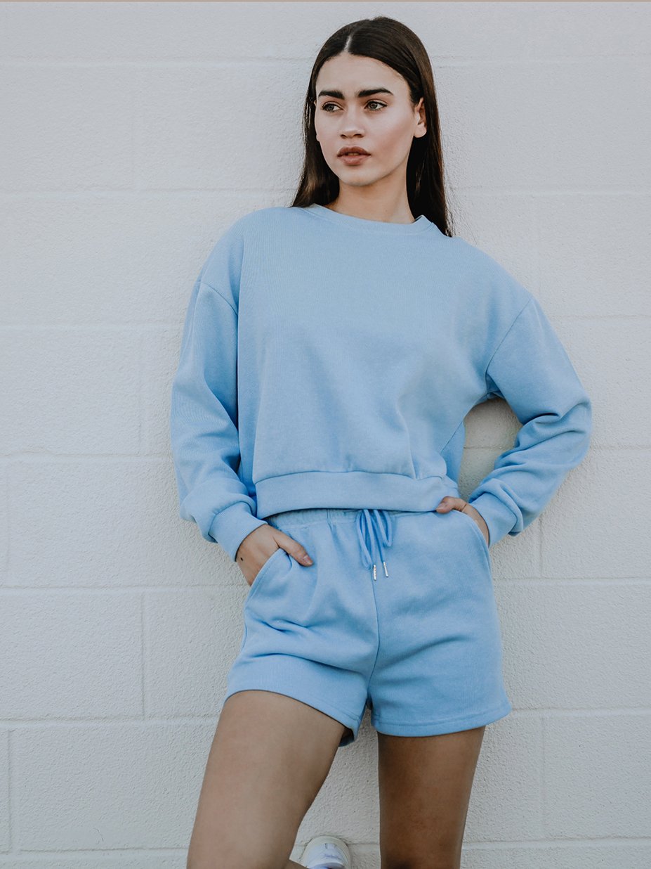 Melly Sweater in pastel color with oversized boxy fit, rounded neckline, and full-length ribbed sleeves displayed on a mannequin.