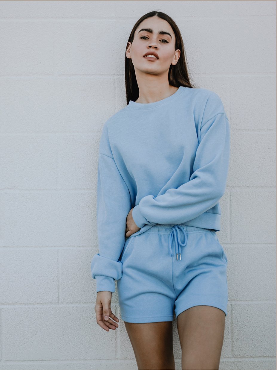 Melly Sweater in pastel color with oversized boxy fit, rounded neckline, and full-length ribbed sleeves displayed on a mannequin.