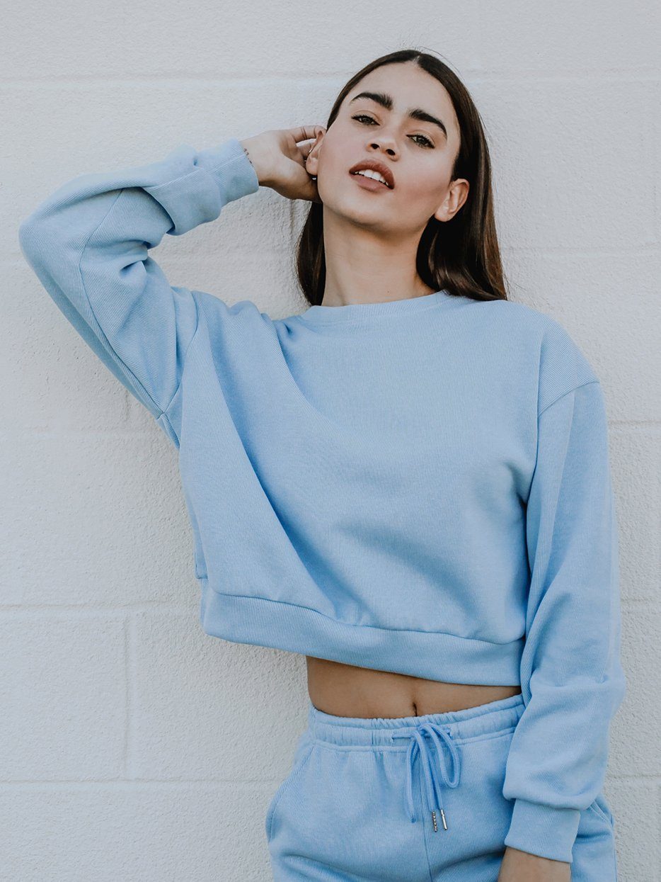 Melly Sweater in pastel color with oversized boxy fit, rounded neckline, and full-length ribbed sleeves displayed on a mannequin.