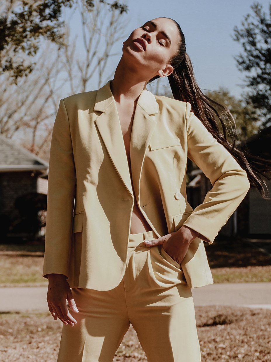 A stylish yellow blazer with an asymmetrical notched collar, single-button front, and welted pockets, designed for confident women.