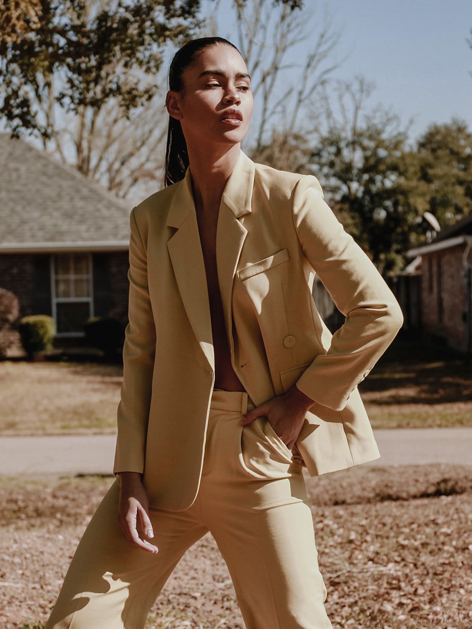 A stylish yellow blazer with an asymmetrical notched collar, single-button front, and welted pockets, designed for confident women.