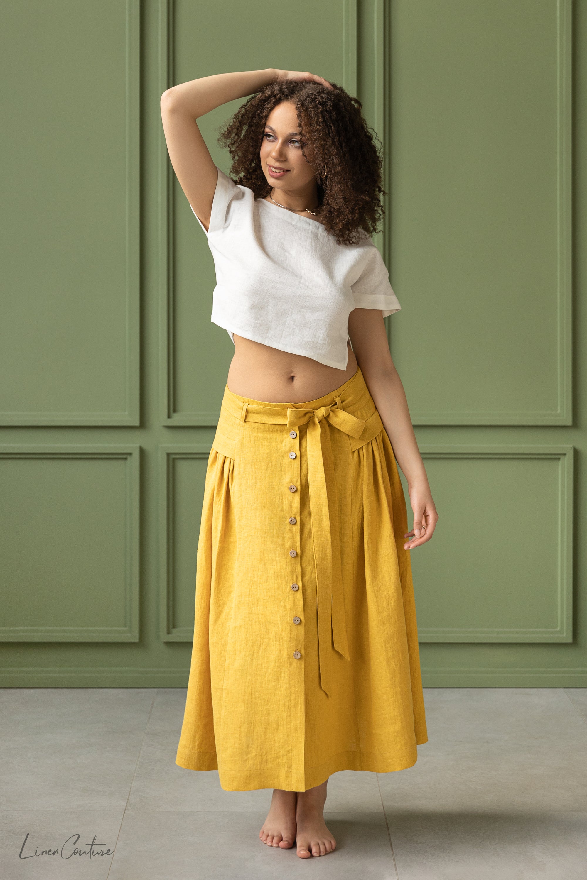 Taormina Honey Linen Crop Top and Midi Skirt Set displayed on a model, showcasing its elegant design and earthy beige color.