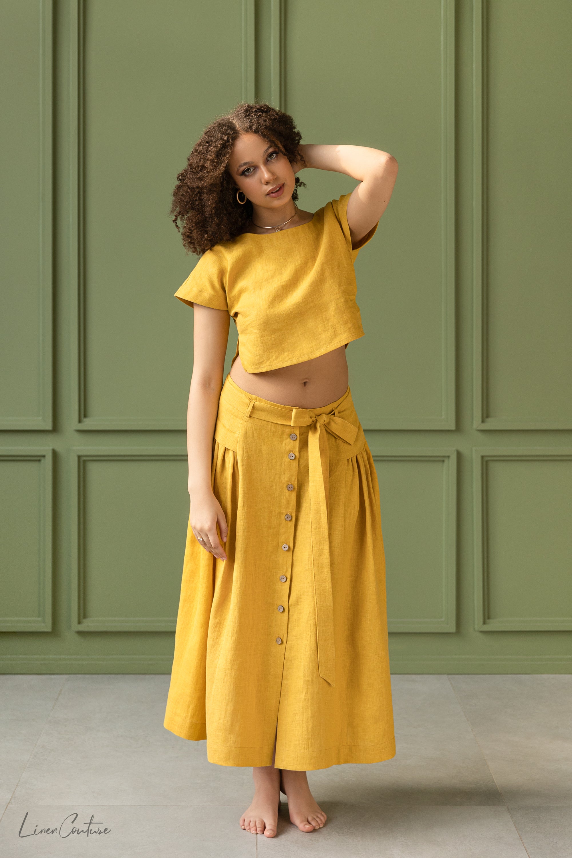 Taormina Honey Linen Crop Top and Midi Skirt Set displayed on a model, showcasing its elegant design and earthy beige color.