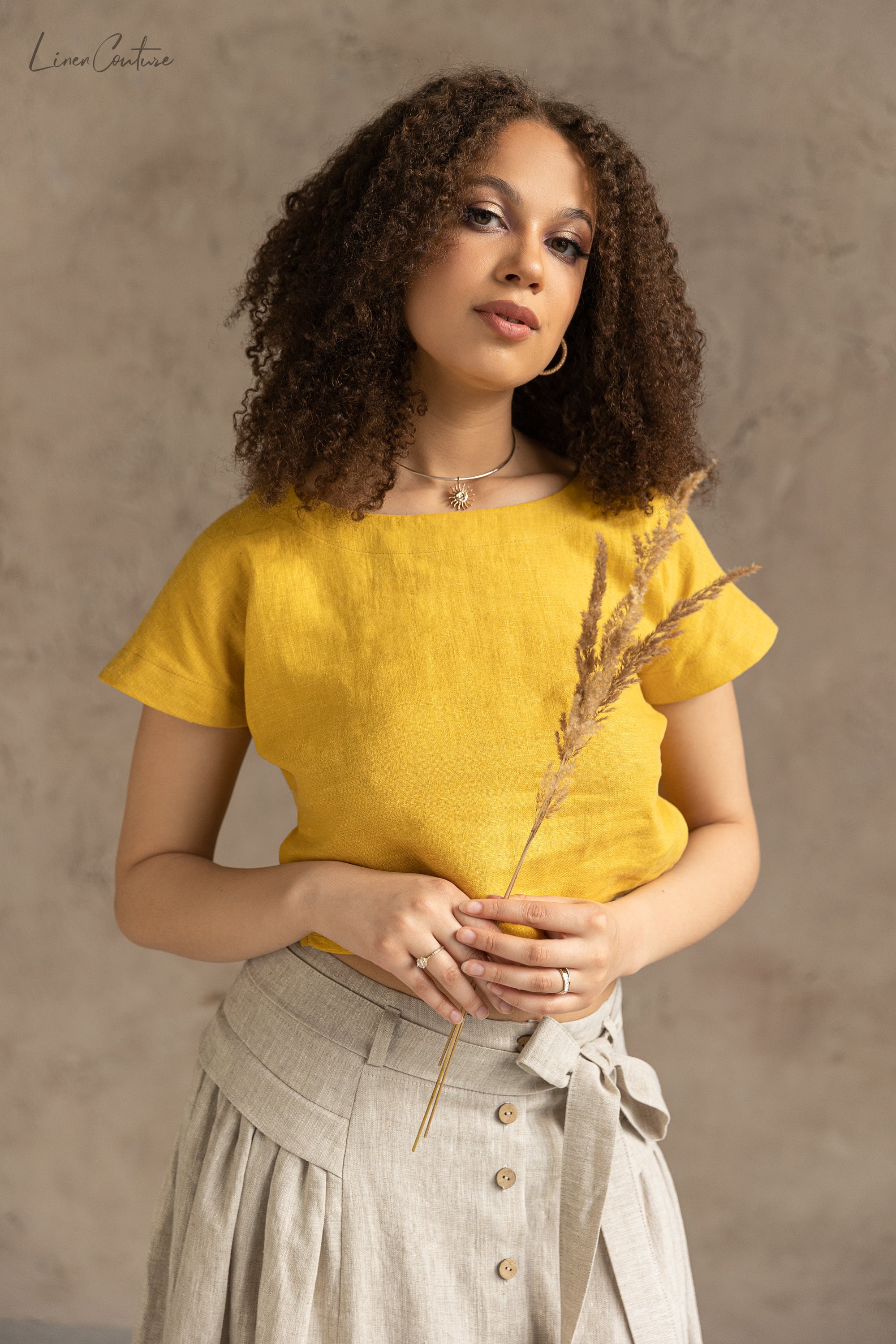 Taormina Honey Linen Crop Top and Midi Skirt Set displayed on a model, showcasing its elegant design and earthy beige color.