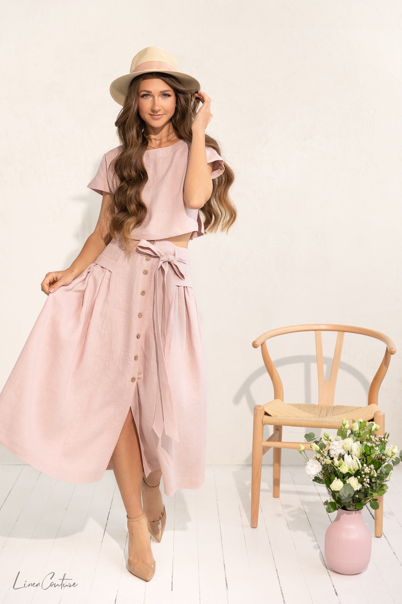 Taormina Pale Pink Linen Crop Top and Midi Skirt Co Ord Set displayed on a model, showcasing its elegant design and breathable fabric.