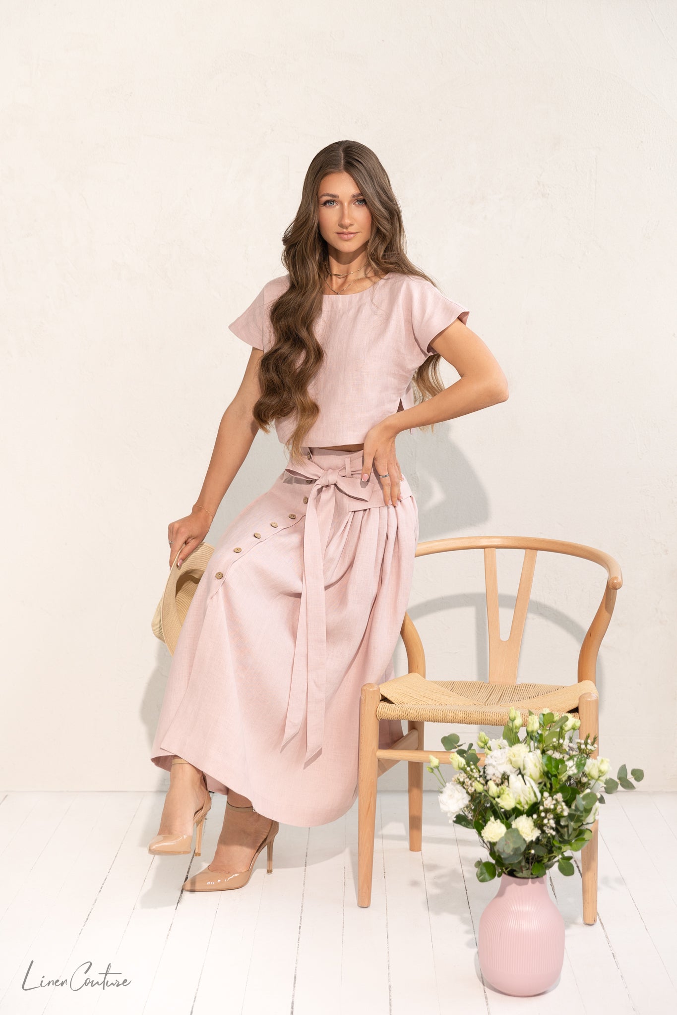 Taormina Pale Pink Linen Crop Top and Midi Skirt Co Ord Set displayed on a model, showcasing its elegant design and breathable fabric.