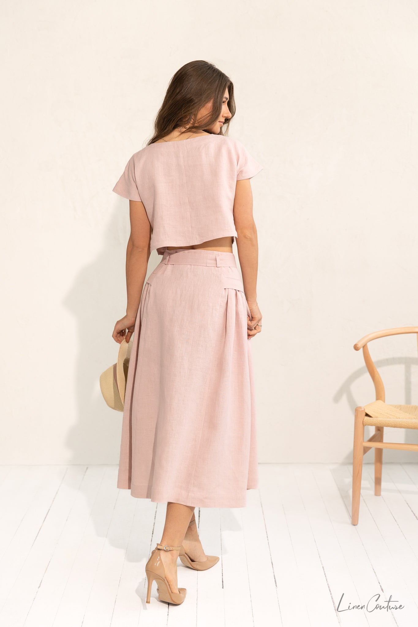 Taormina Pale Pink Linen Crop Top and Midi Skirt Co Ord Set displayed on a model, showcasing its elegant design and breathable fabric.