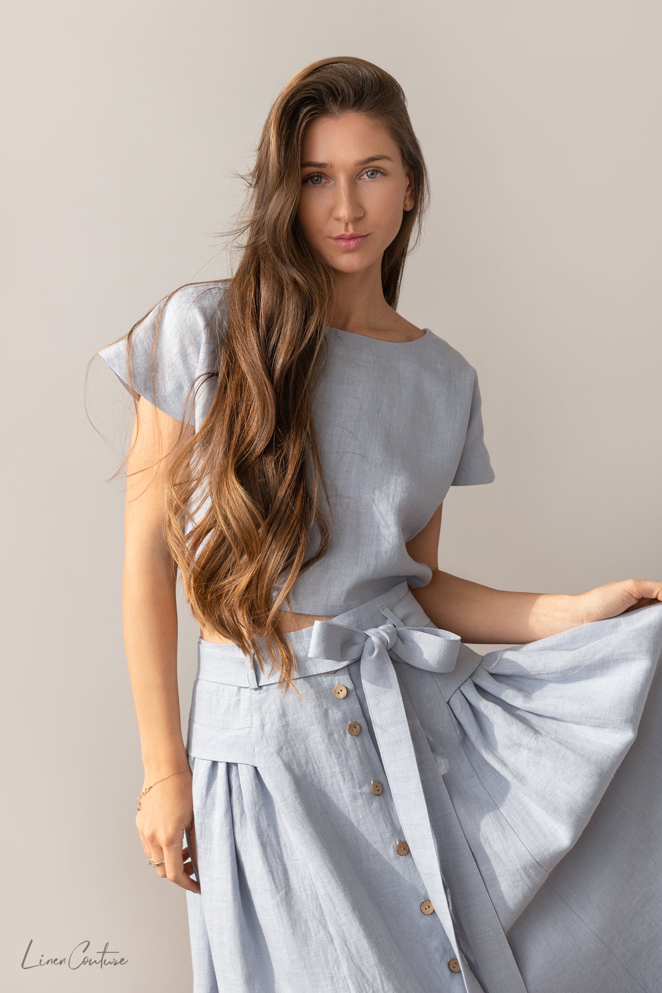 Taormina Pale Pink Linen Crop Top and Midi Skirt Co Ord Set displayed on a model, showcasing its elegant design and breathable fabric.