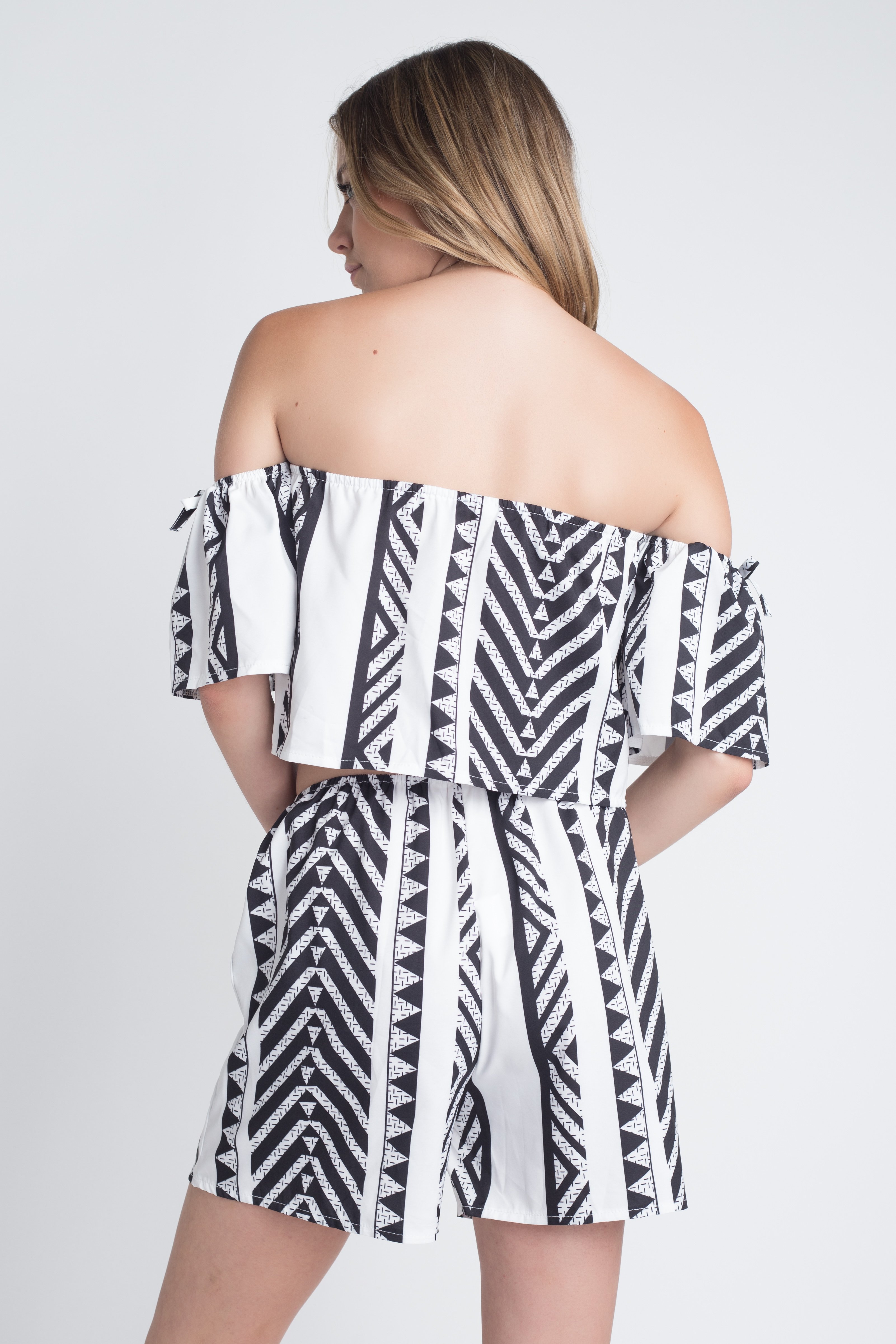 Woman in an off-shoulder romper.