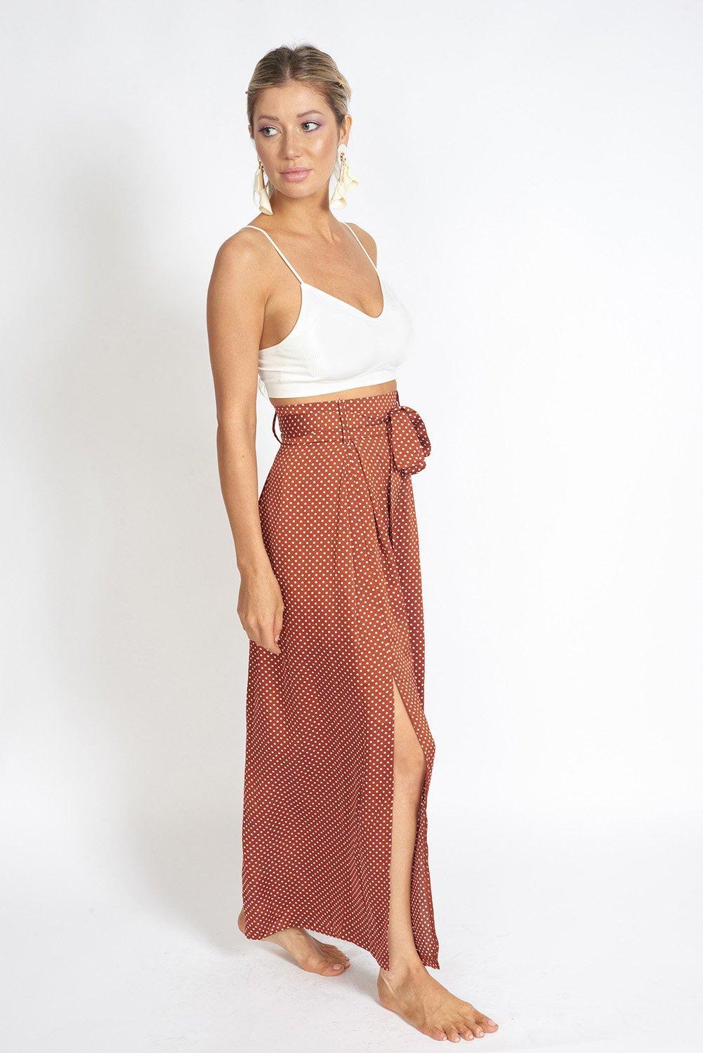 Alessandra Wide Leg Slit Pants featuring a polka-dot print, high-rise waist, and stylish knee slit.