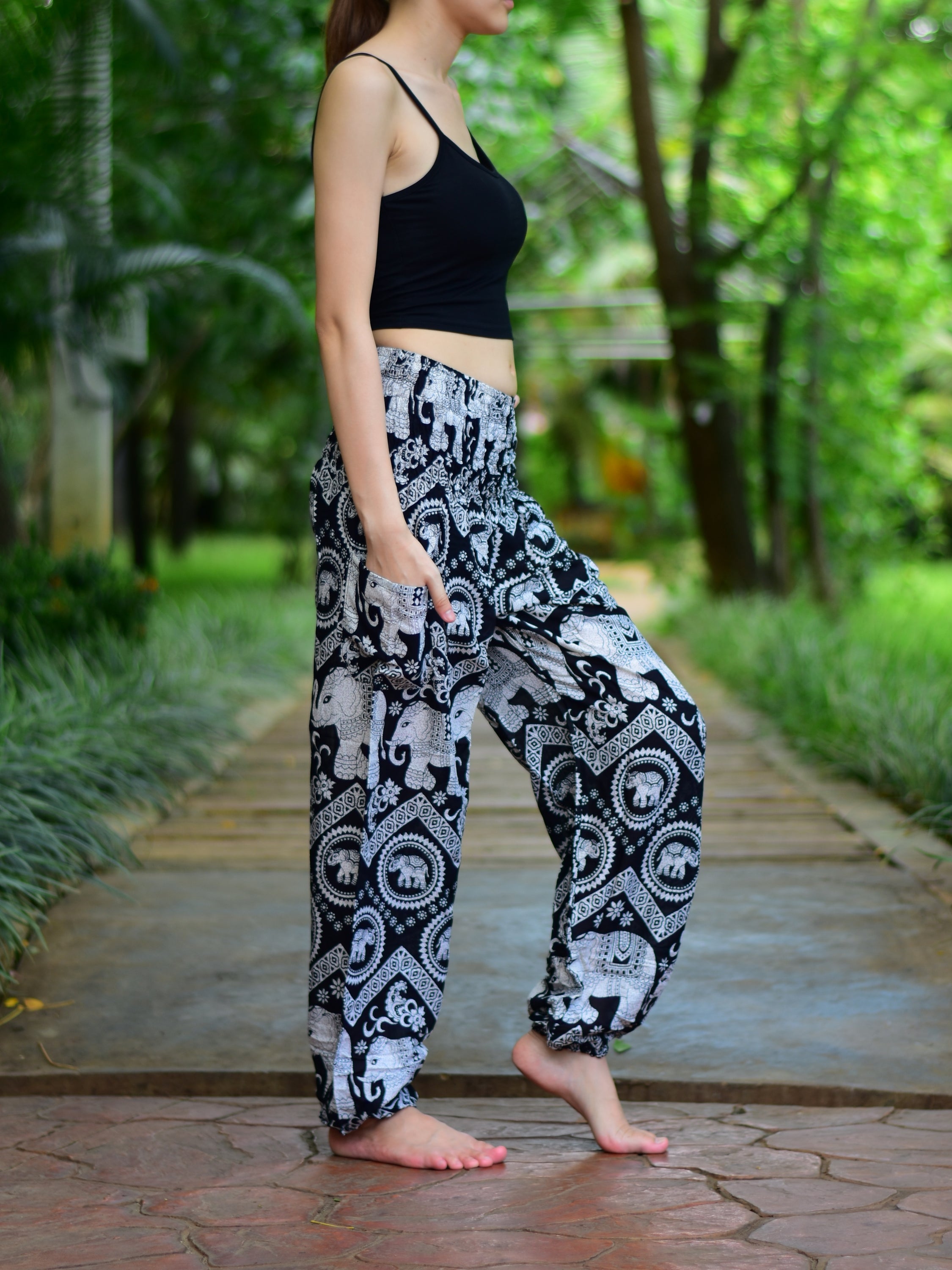 Bohotusk Black Elephant Paradise Print trousers with elasticated smocked waist, showcasing vibrant colors and a stylish design.