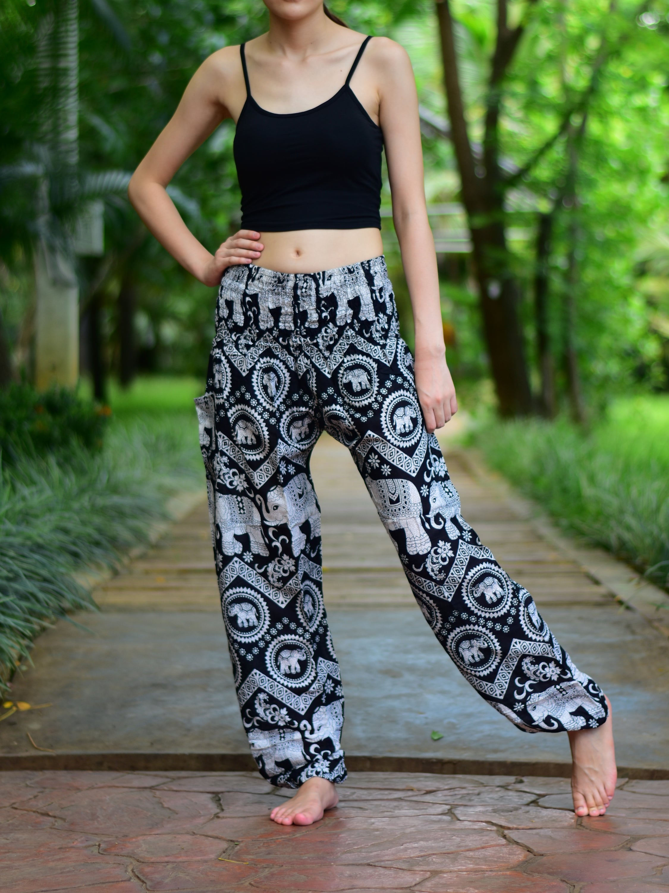 Bohotusk Black Elephant Paradise Print trousers with elasticated smocked waist, showcasing vibrant colors and a stylish design.