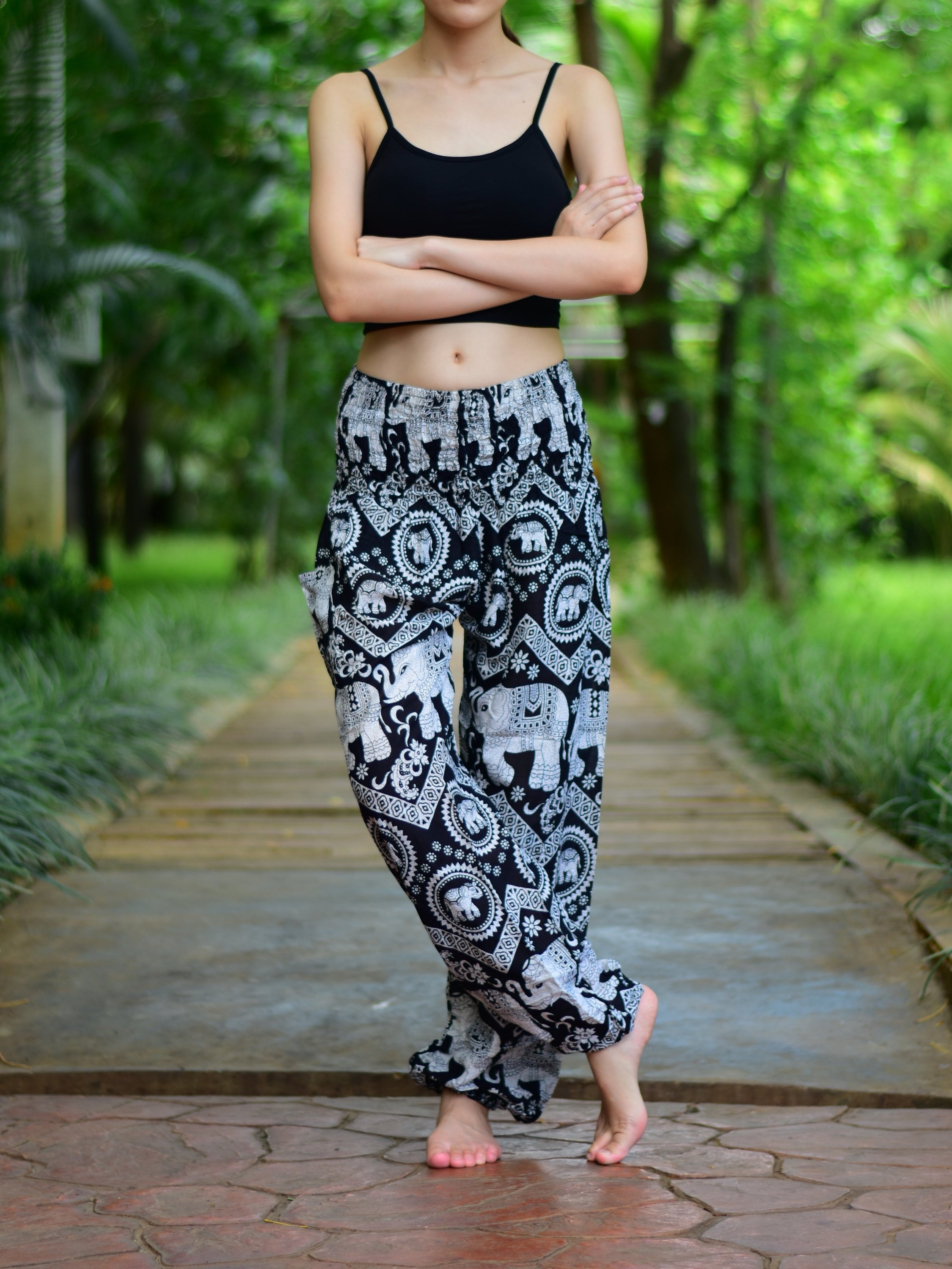 Bohotusk Black Elephant Paradise Print trousers with elasticated smocked waist, showcasing vibrant colors and a stylish design.