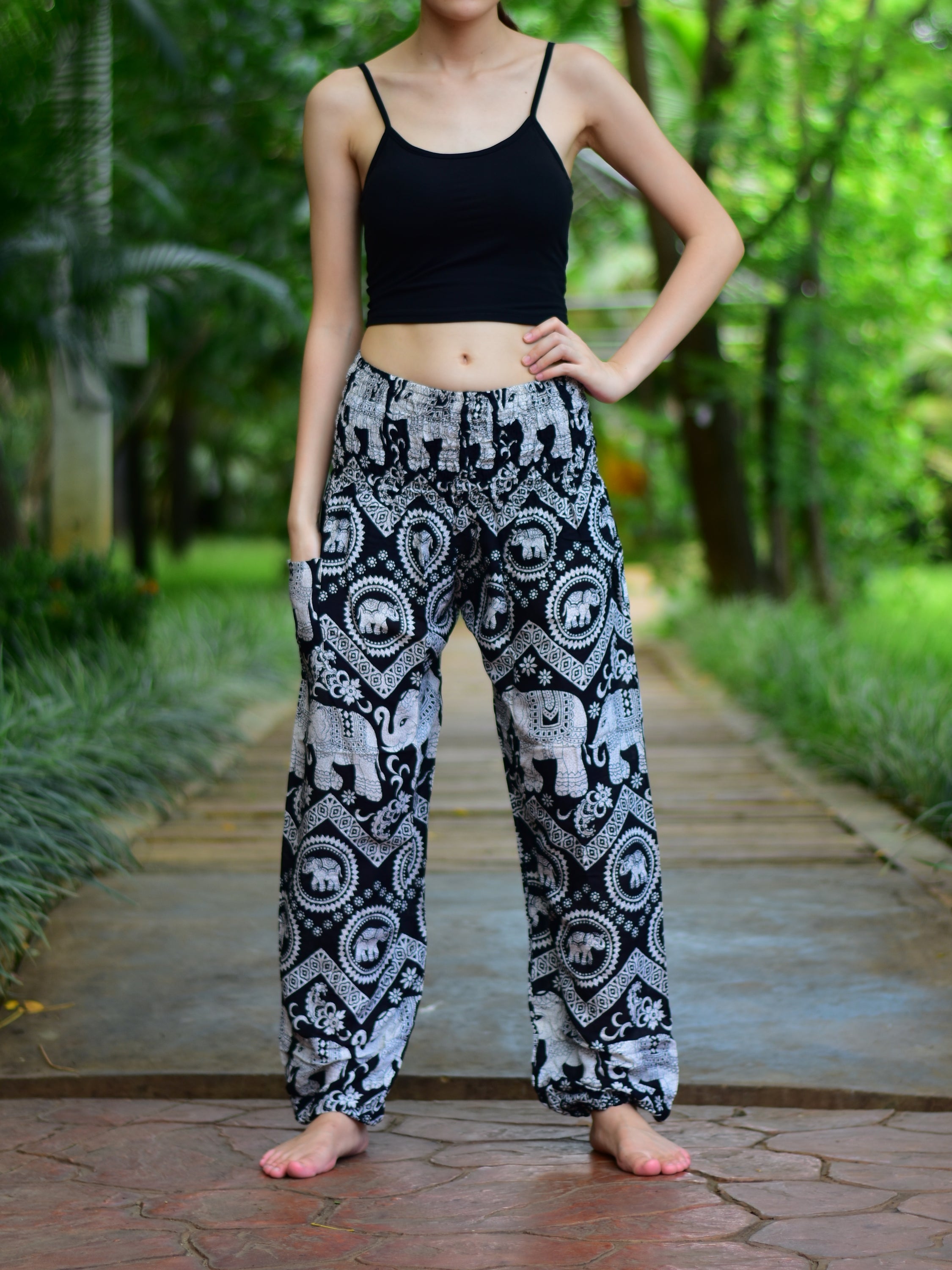 Bohotusk Black Elephant Paradise Print trousers with elasticated smocked waist, showcasing vibrant colors and a stylish design.