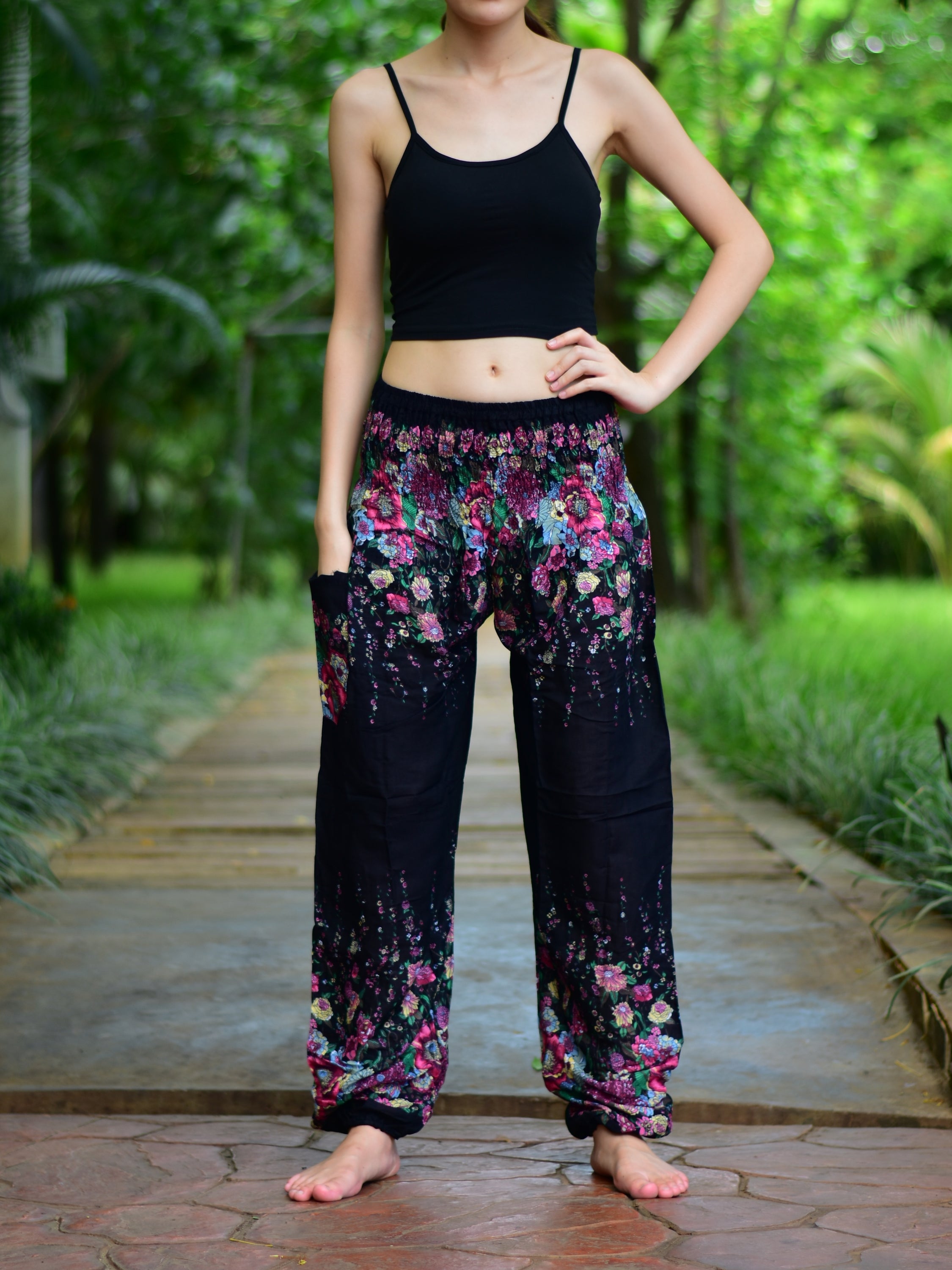 Bohotusk Black Floral Print Elasticated Smocked Waist Womens Harem pants displayed on a model, showcasing the floral design and elasticated waist.