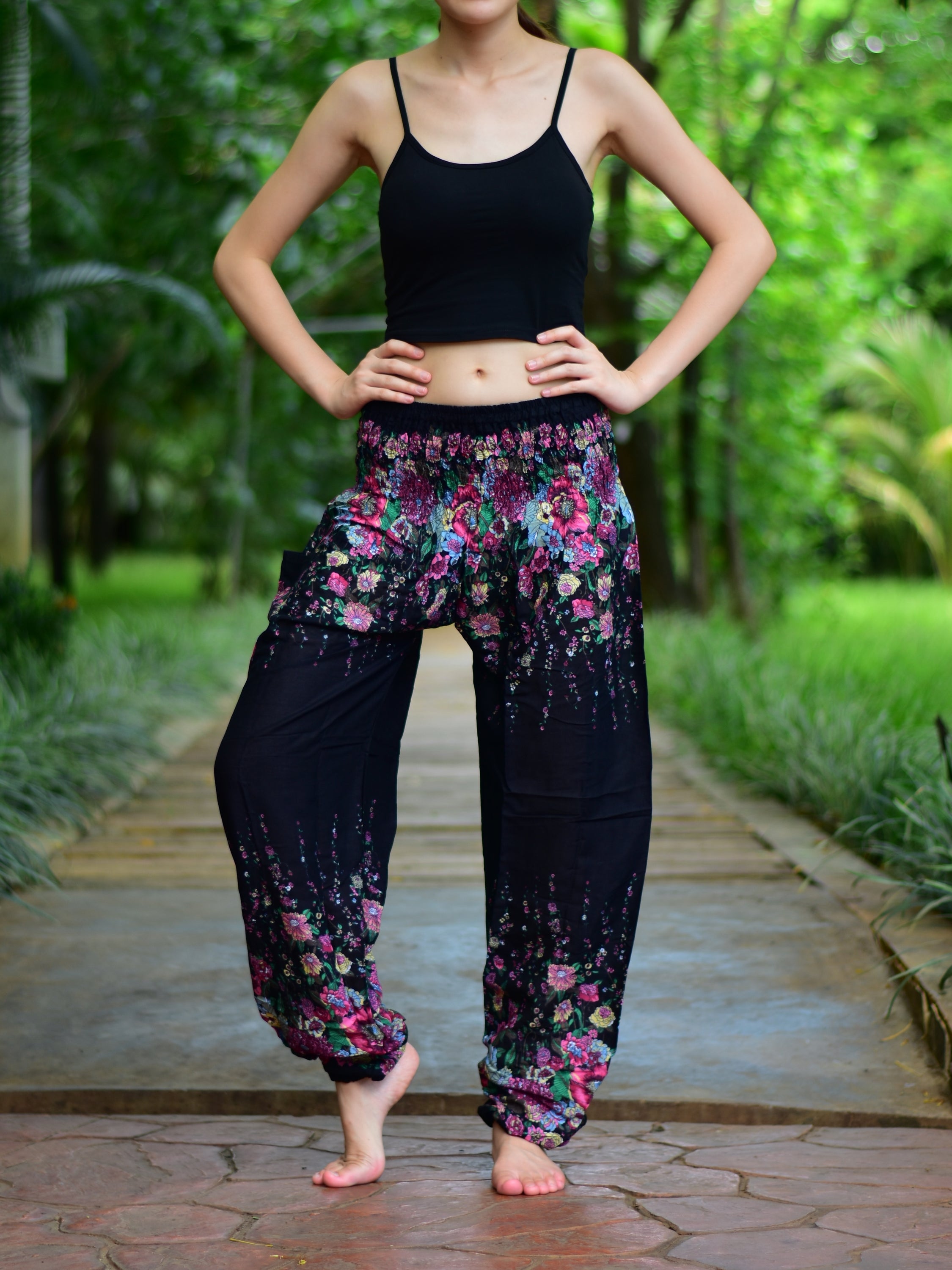 Bohotusk Black Floral Print Elasticated Smocked Waist Womens Harem pants displayed on a model, showcasing the floral design and elasticated waist.