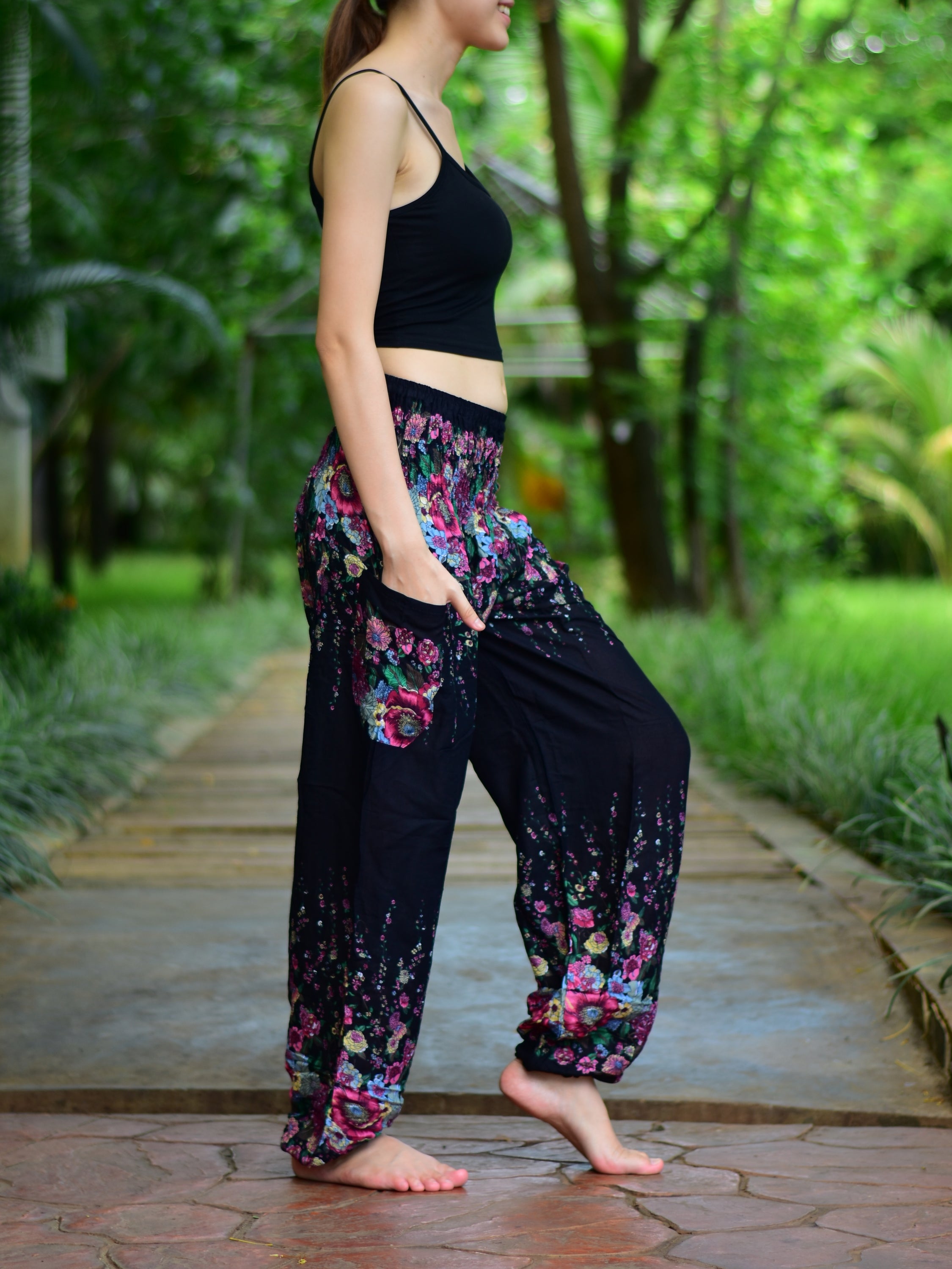 Bohotusk Black Floral Print Elasticated Smocked Waist Womens Harem pants displayed on a model, showcasing the floral design and elasticated waist.