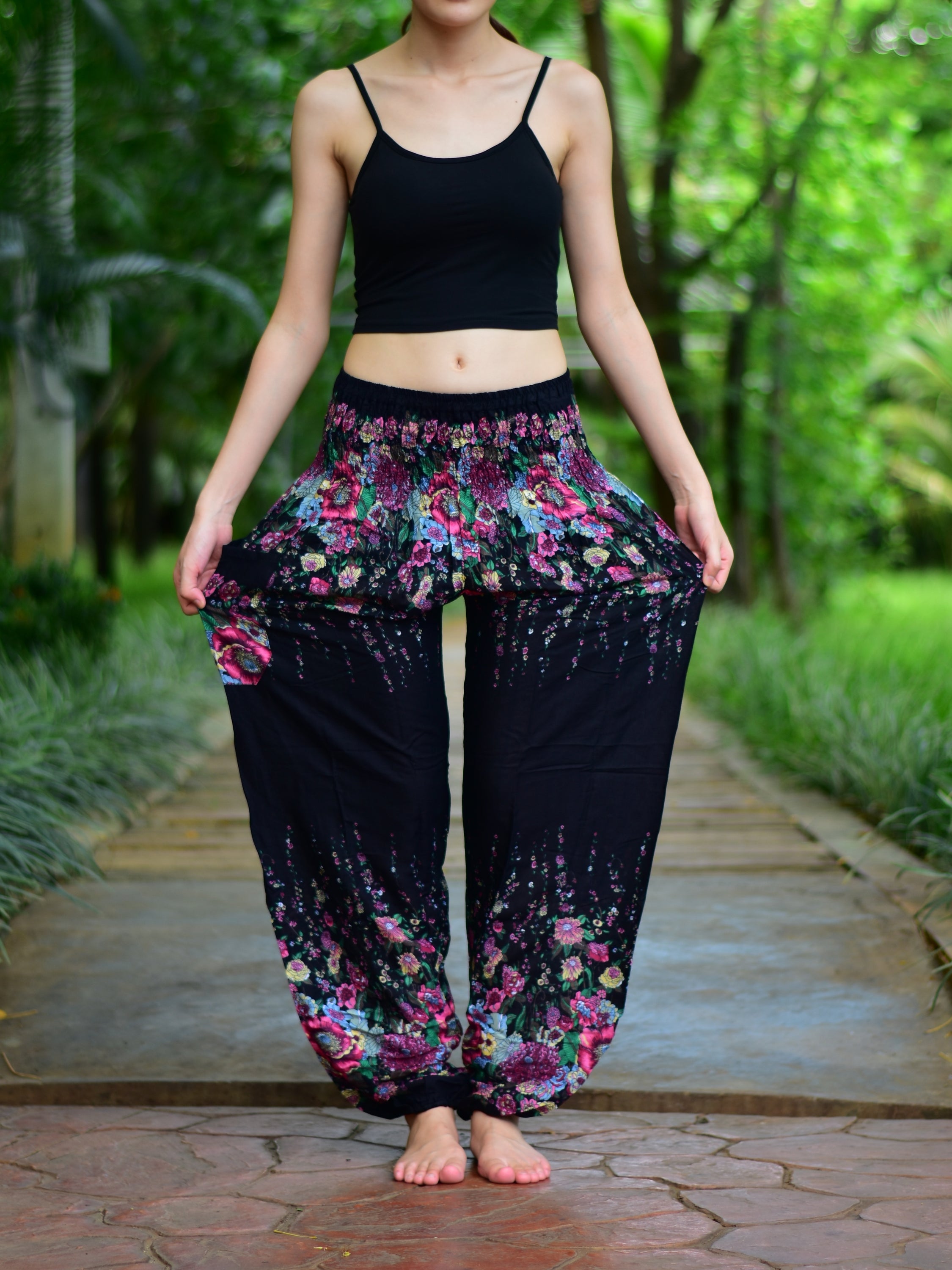 Bohotusk Black Floral Print Elasticated Smocked Waist Womens Harem pants displayed on a model, showcasing the floral design and elasticated waist.