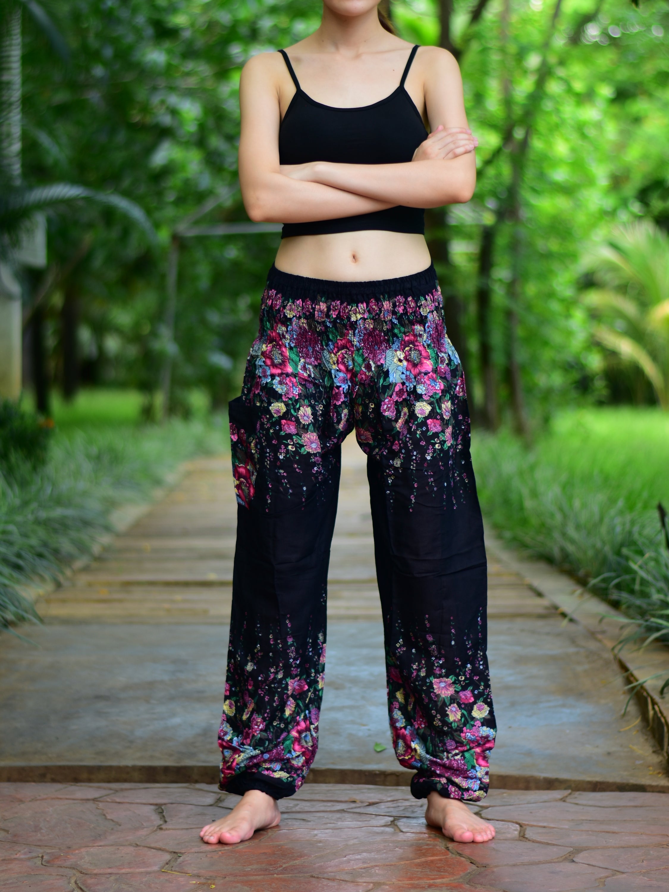 Bohotusk Black Floral Print Elasticated Smocked Waist Womens Harem pants displayed on a model, showcasing the floral design and elasticated waist.