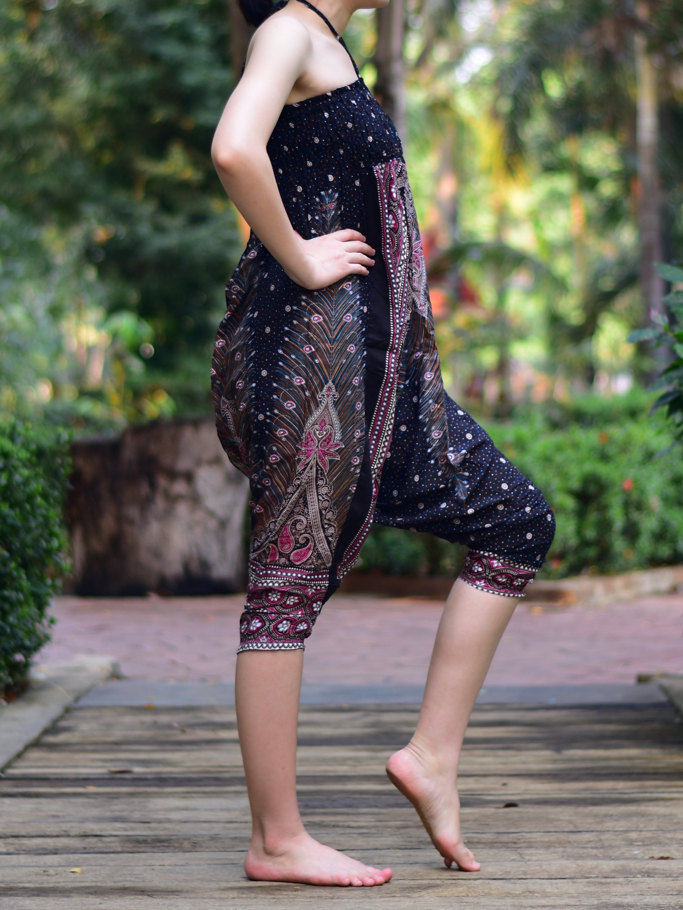 Bohotusk Black Peacock Print Jumpsuit showcasing its elegant design and vibrant colors, perfect for versatile styling.