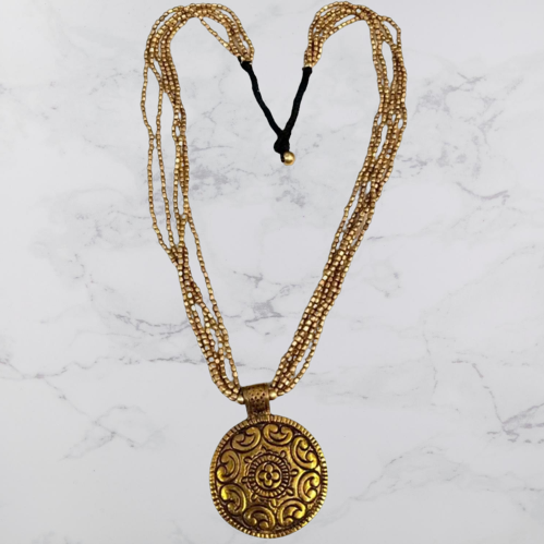 Bohotusk Brass Multi Chain Shield Pendant featuring a 6.5cm diameter brass shield on a 54cm multi-part chain.