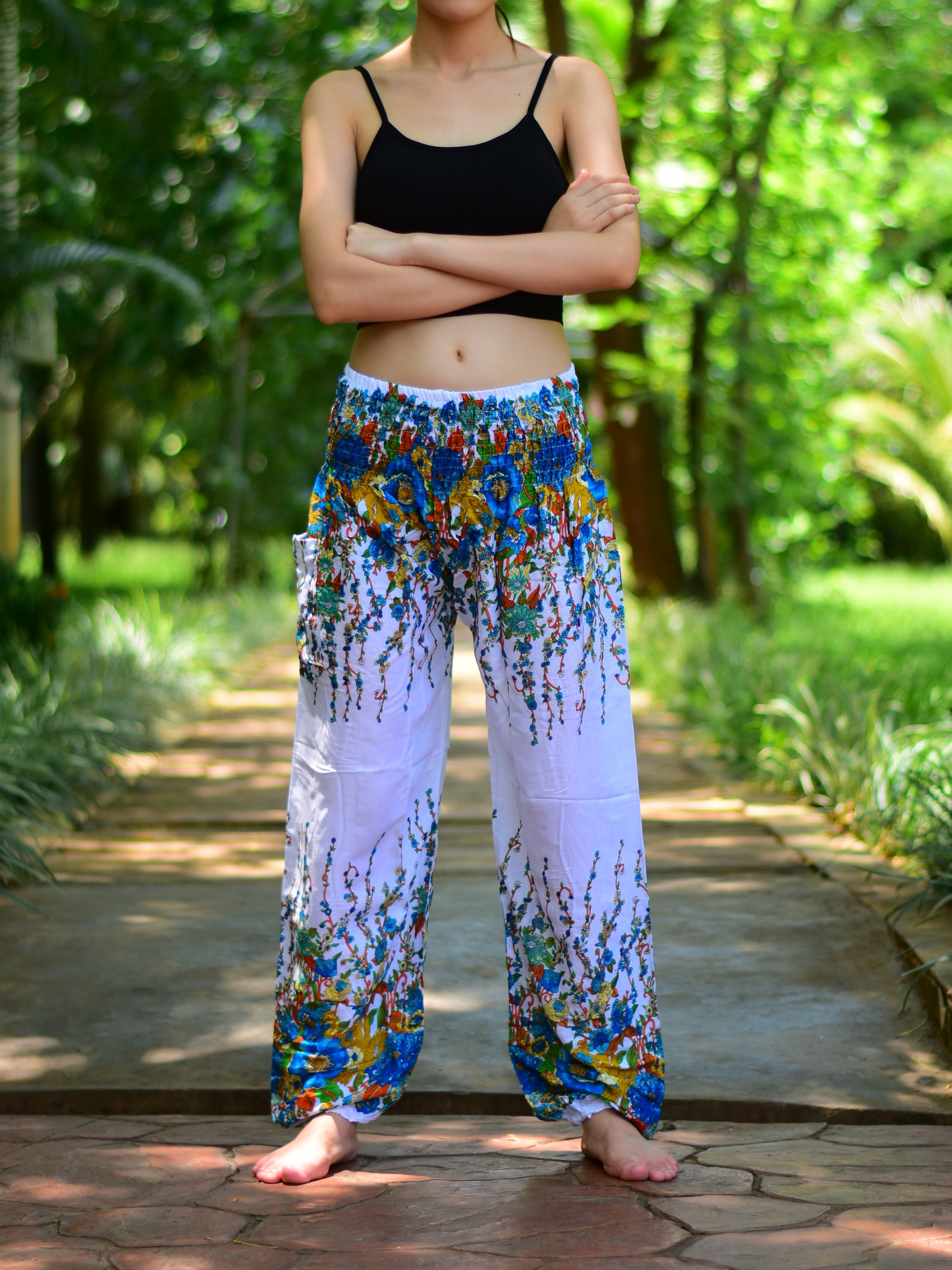 Bohotusk White Floral Print Elasticated Smocked Waist Womens Harem pants displayed on a model, showcasing the floral design and elasticated waist.