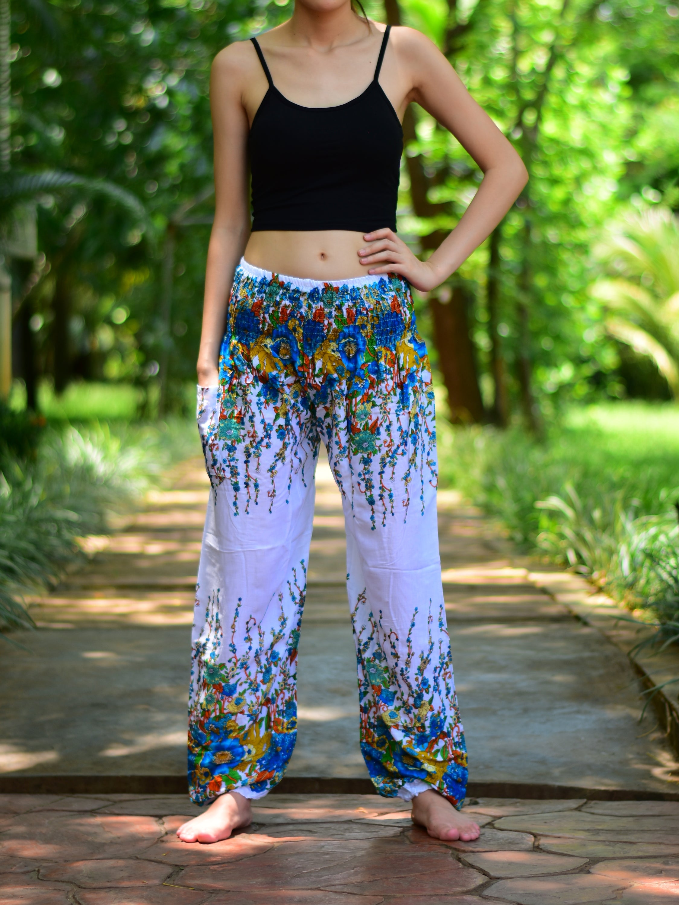 Bohotusk White Floral Print Elasticated Smocked Waist Womens Harem pants displayed on a model, showcasing the floral design and elasticated waist.