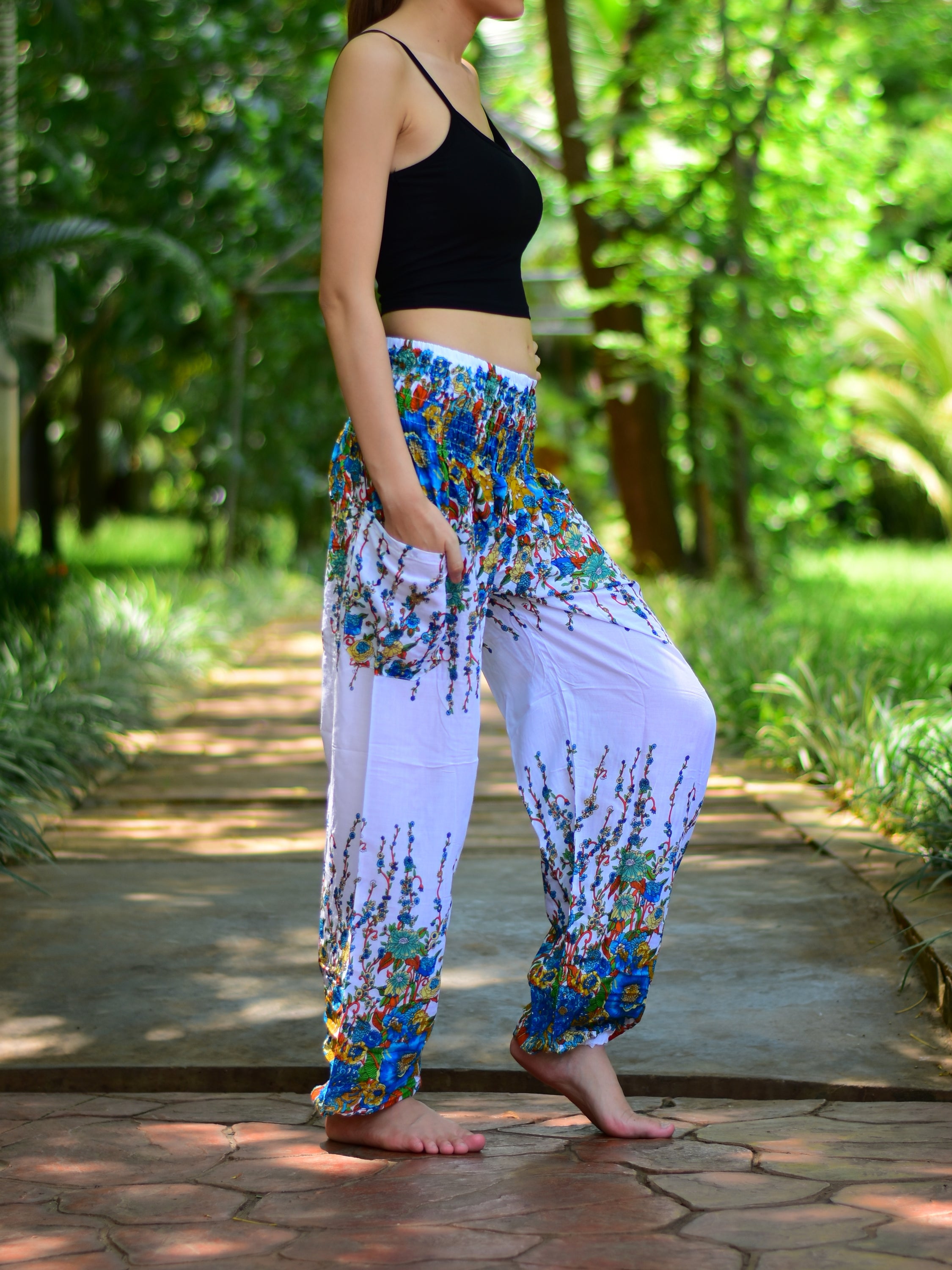 Bohotusk White Floral Print Elasticated Smocked Waist Womens Harem pants displayed on a model, showcasing the floral design and elasticated waist.