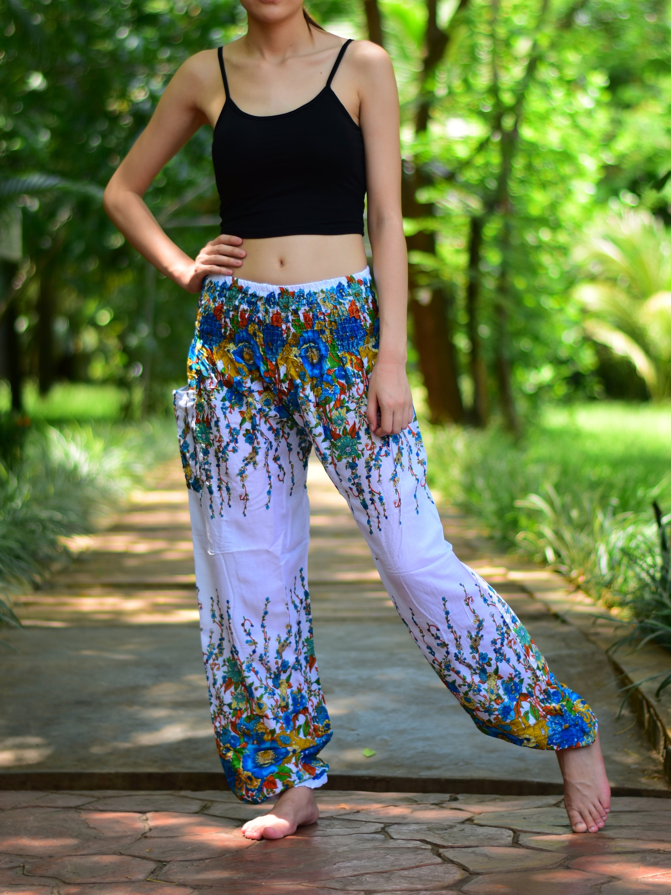 Bohotusk White Floral Print Elasticated Smocked Waist Womens Harem pants displayed on a model, showcasing the floral design and elasticated waist.