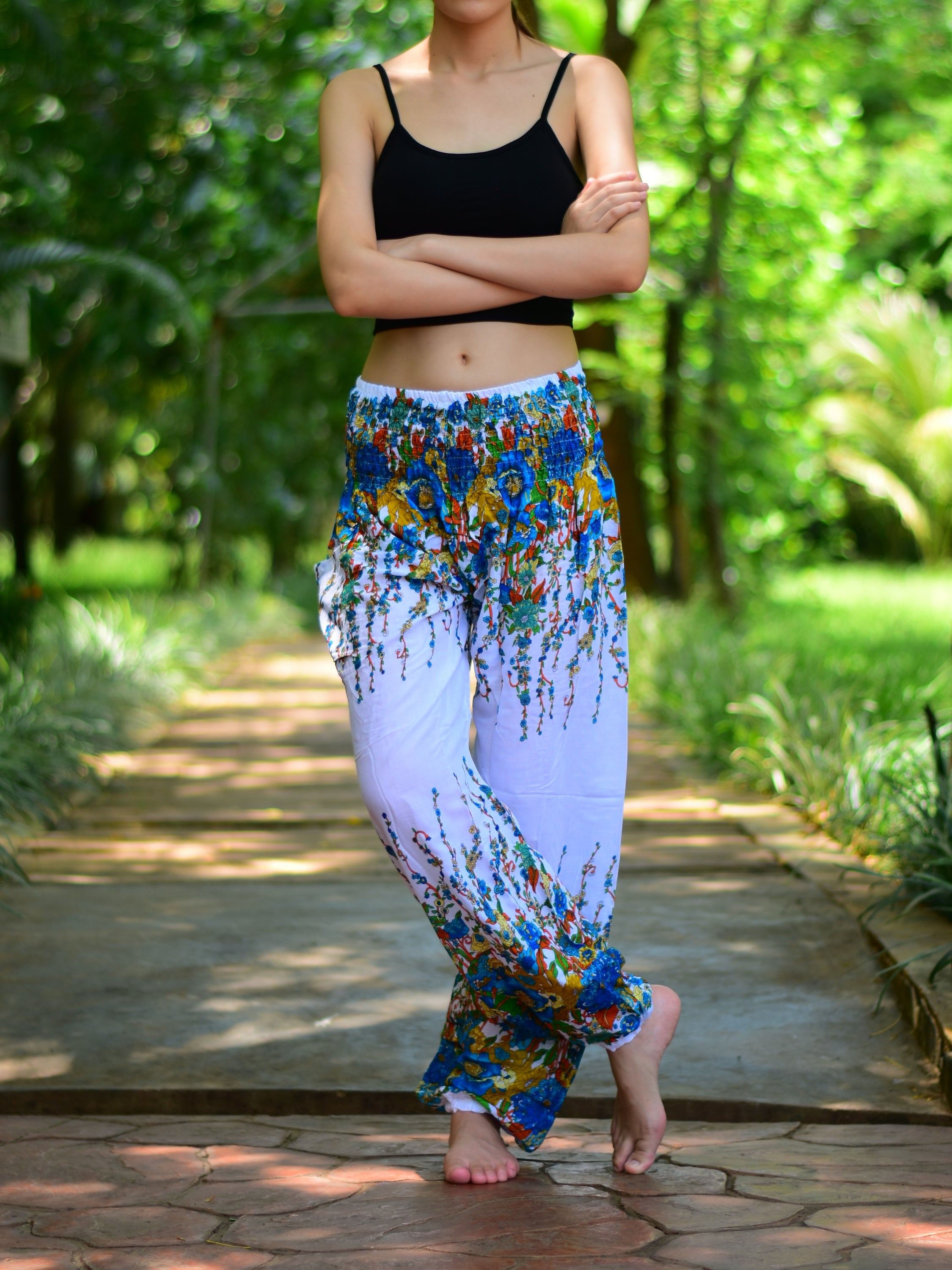 Bohotusk White Floral Print Elasticated Smocked Waist Womens Harem pants displayed on a model, showcasing the floral design and elasticated waist.