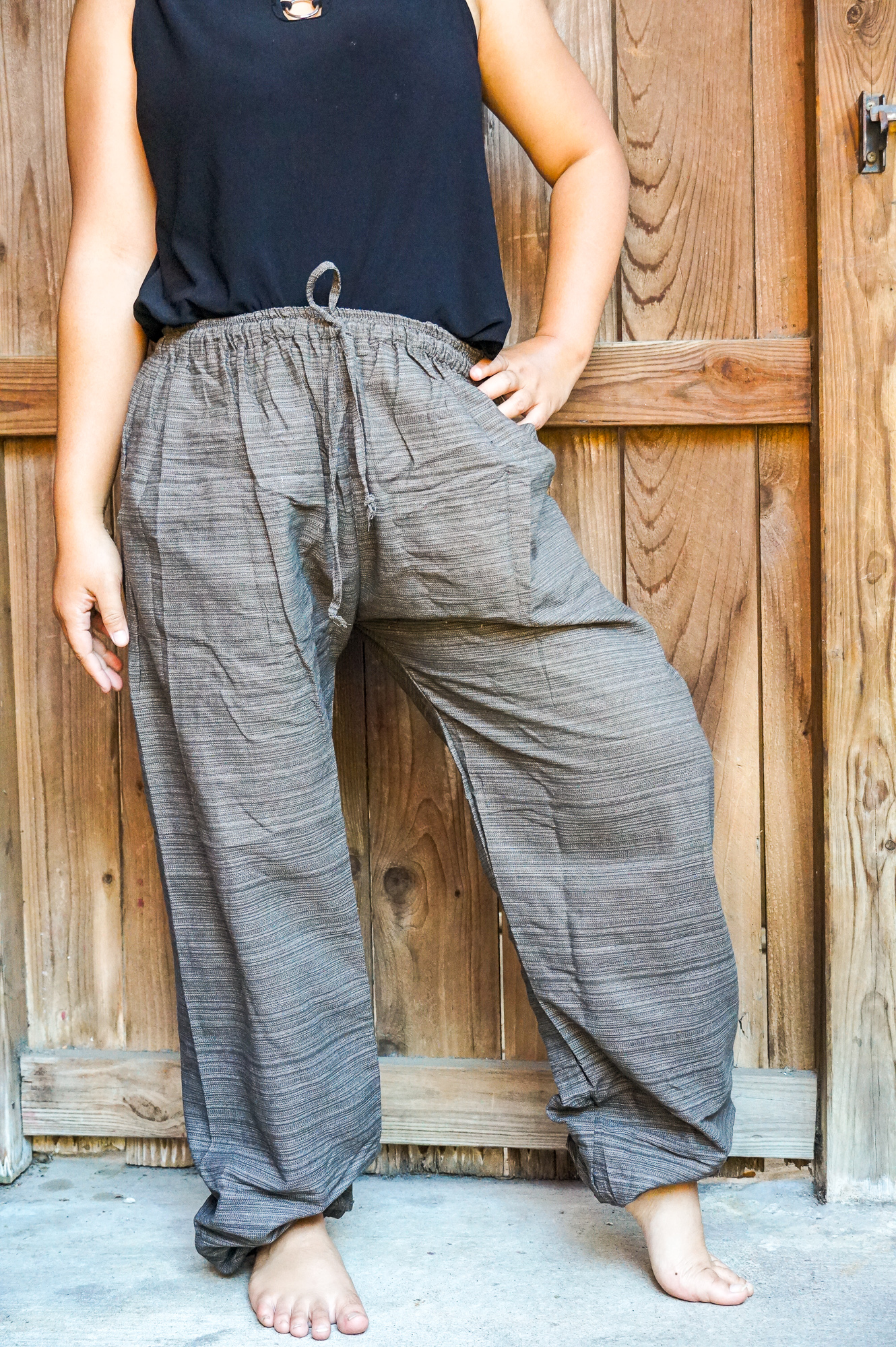 A pair of stylish Cotton Boho Hippie Gypsy Pants in soft cotton, featuring an elastic drawstring waist and two side pockets, perfect for casual wear.