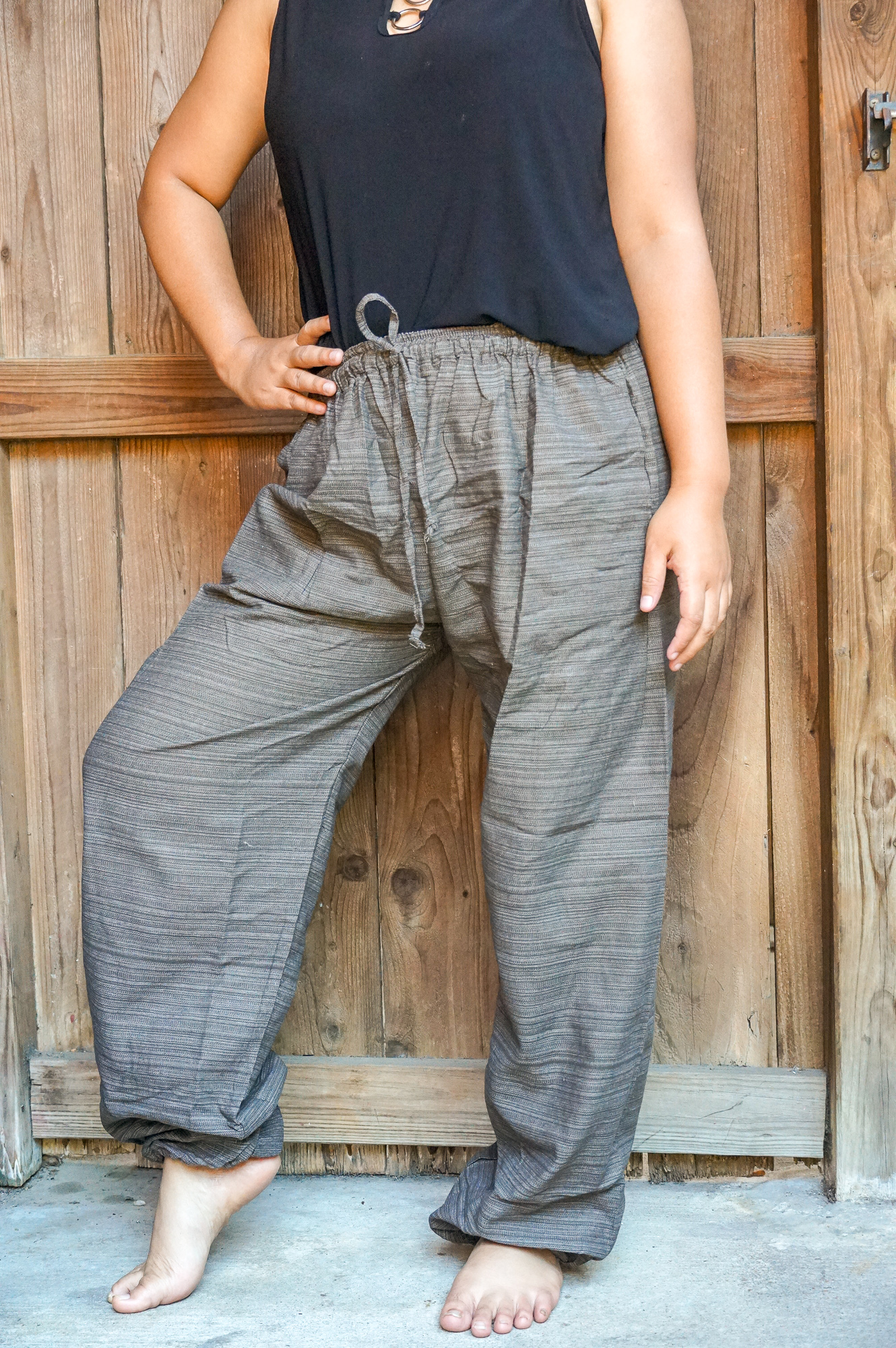 A pair of stylish Cotton Boho Hippie Gypsy Pants in soft cotton, featuring an elastic drawstring waist and two side pockets, perfect for casual wear.