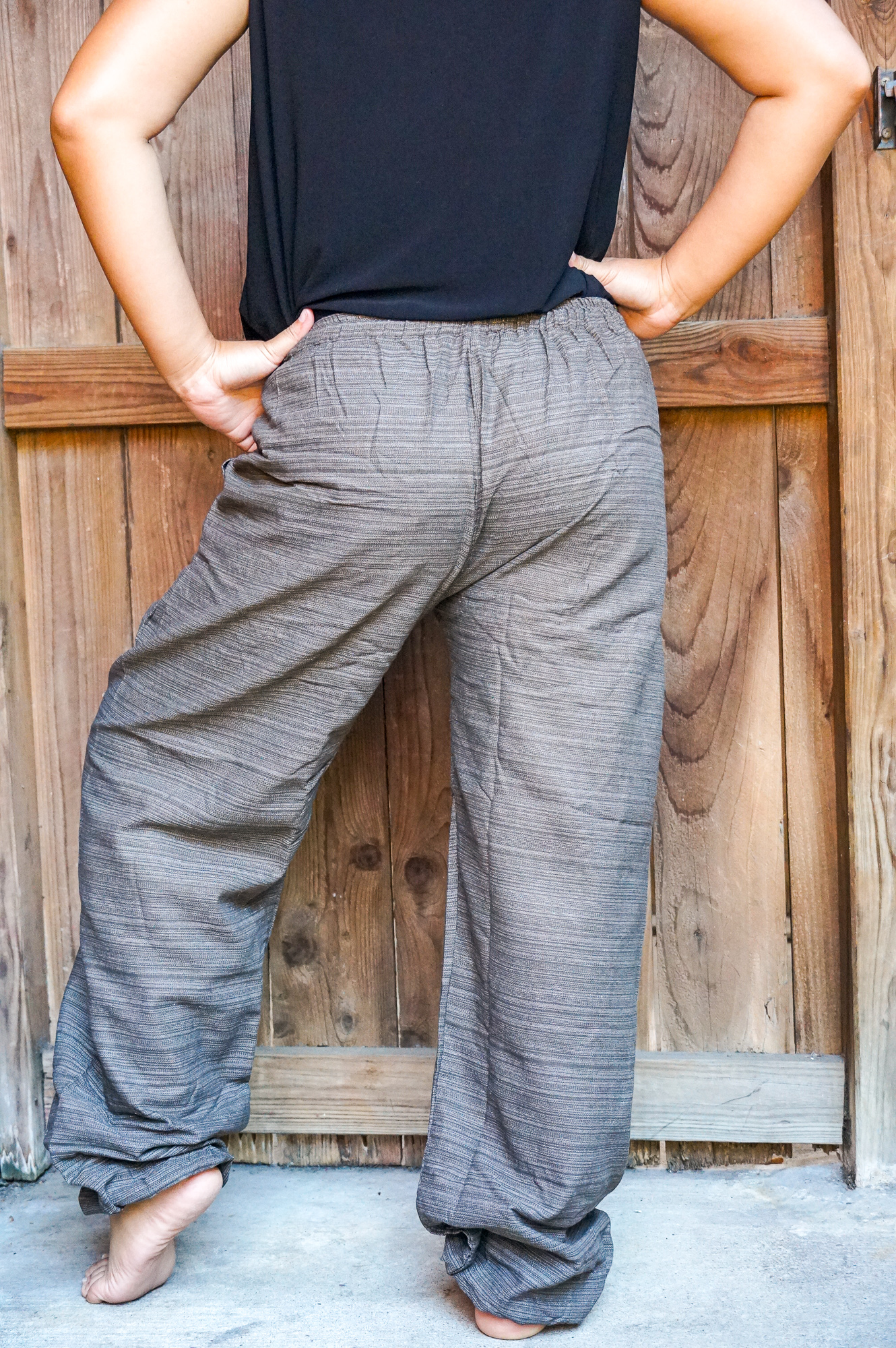 A pair of stylish Cotton Boho Hippie Gypsy Pants in soft cotton, featuring an elastic drawstring waist and two side pockets, perfect for casual wear.