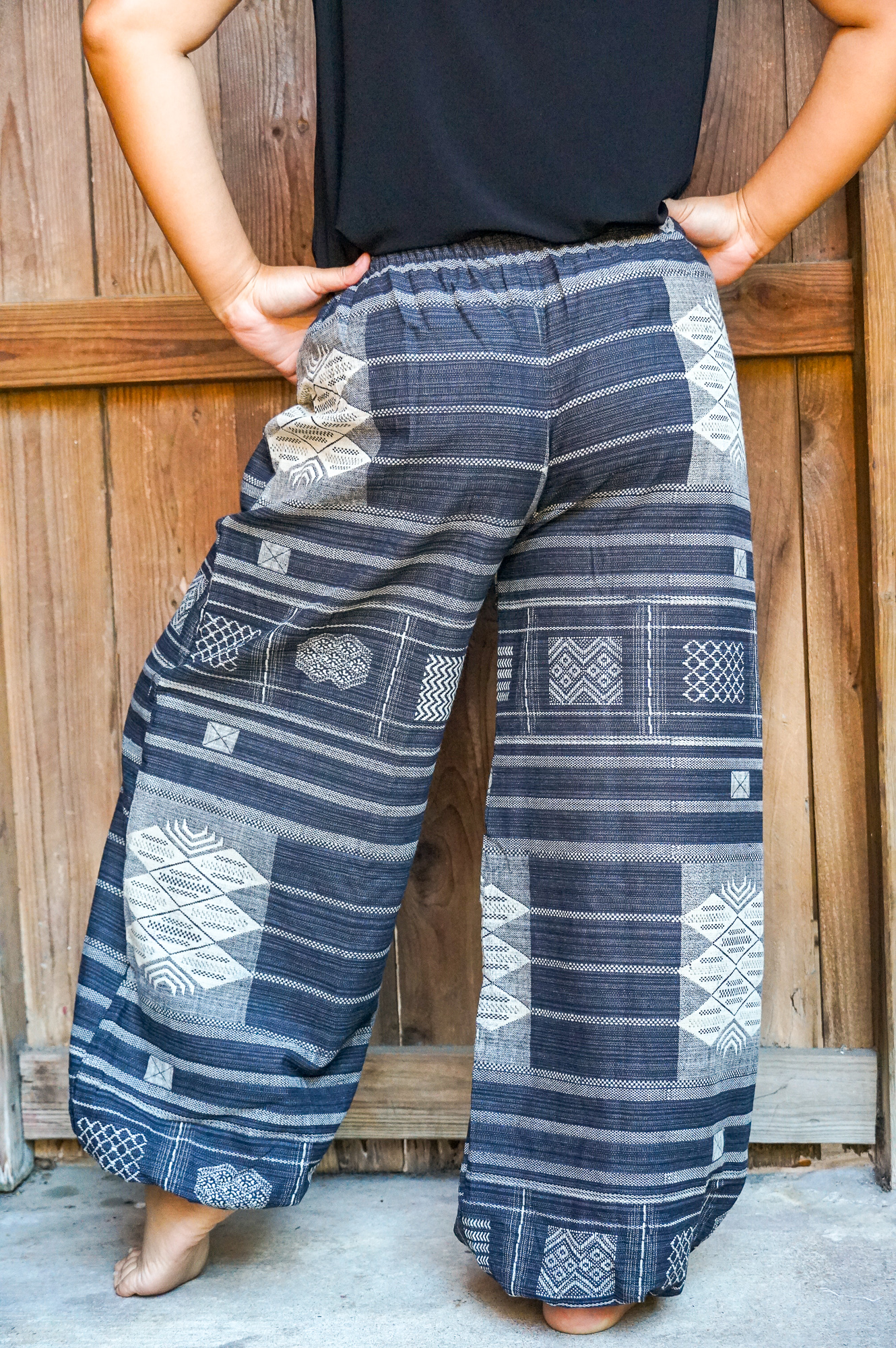 A pair of Cotton Women Tribal Boho Pants featuring a soft cotton fabric, elastic drawstring waist, and tribal rims at the hips, perfect for a bohemian look.