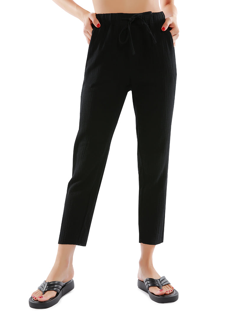 Lightweight drawstring narrow bottom summer pants in cotton, featuring an elasticated waist and multiple pockets.