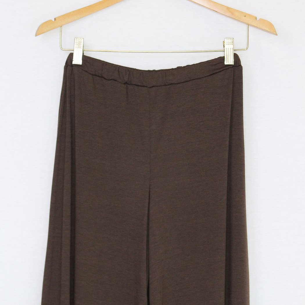 Brown elastic waist wide leg pants displayed on a hanger, showcasing their stylish design and comfortable fit.