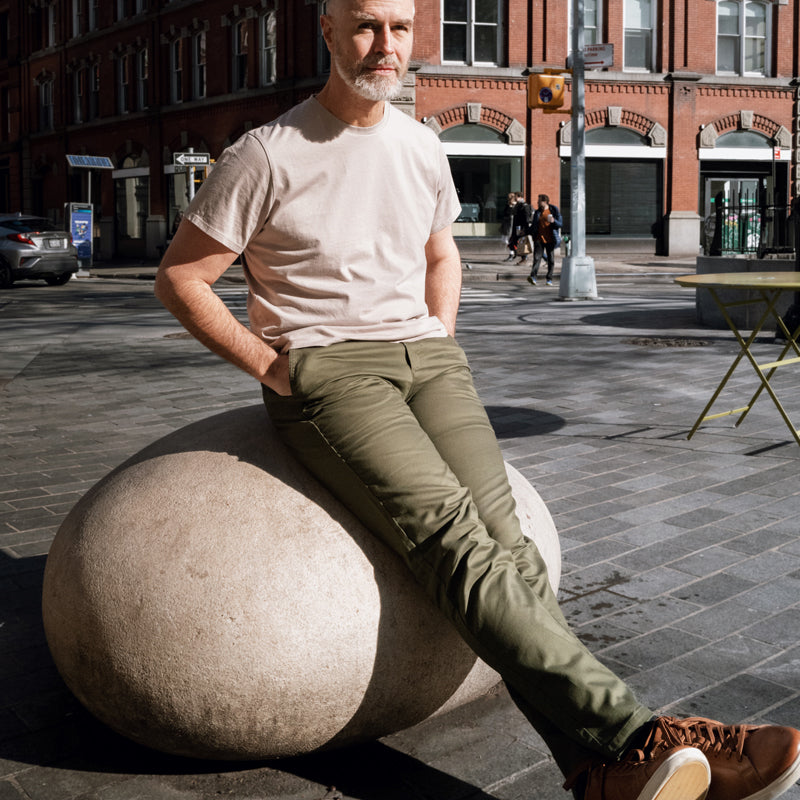 A pair of olive camo chinos designed for active men, showcasing a slim tapered fit and comfortable fabric.