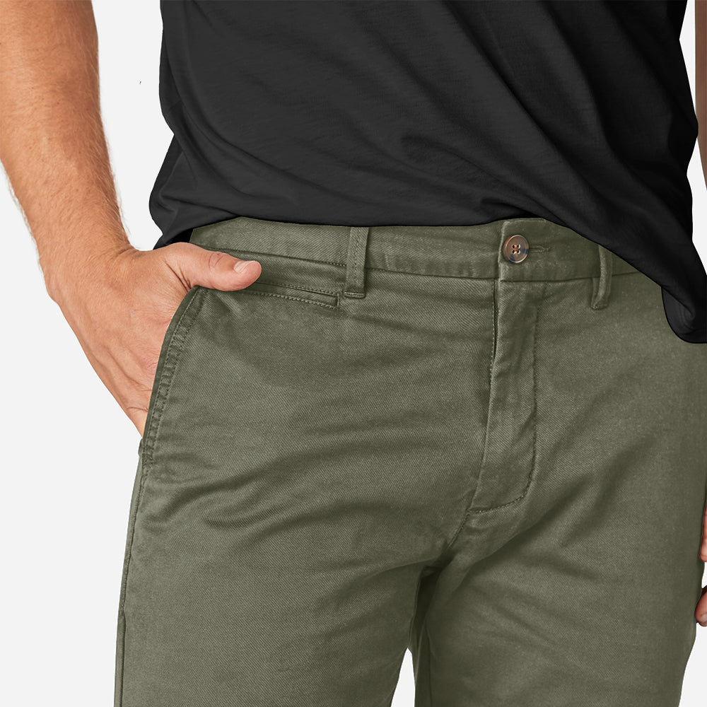 A pair of olive camo chinos designed for active men, showcasing a slim tapered fit and comfortable fabric.