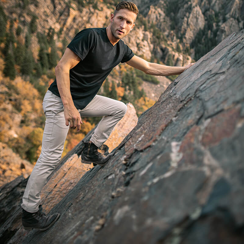 A pair of light khaki chinos designed for comfort and style, featuring a slim tapered fit and a curved waist for added comfort.