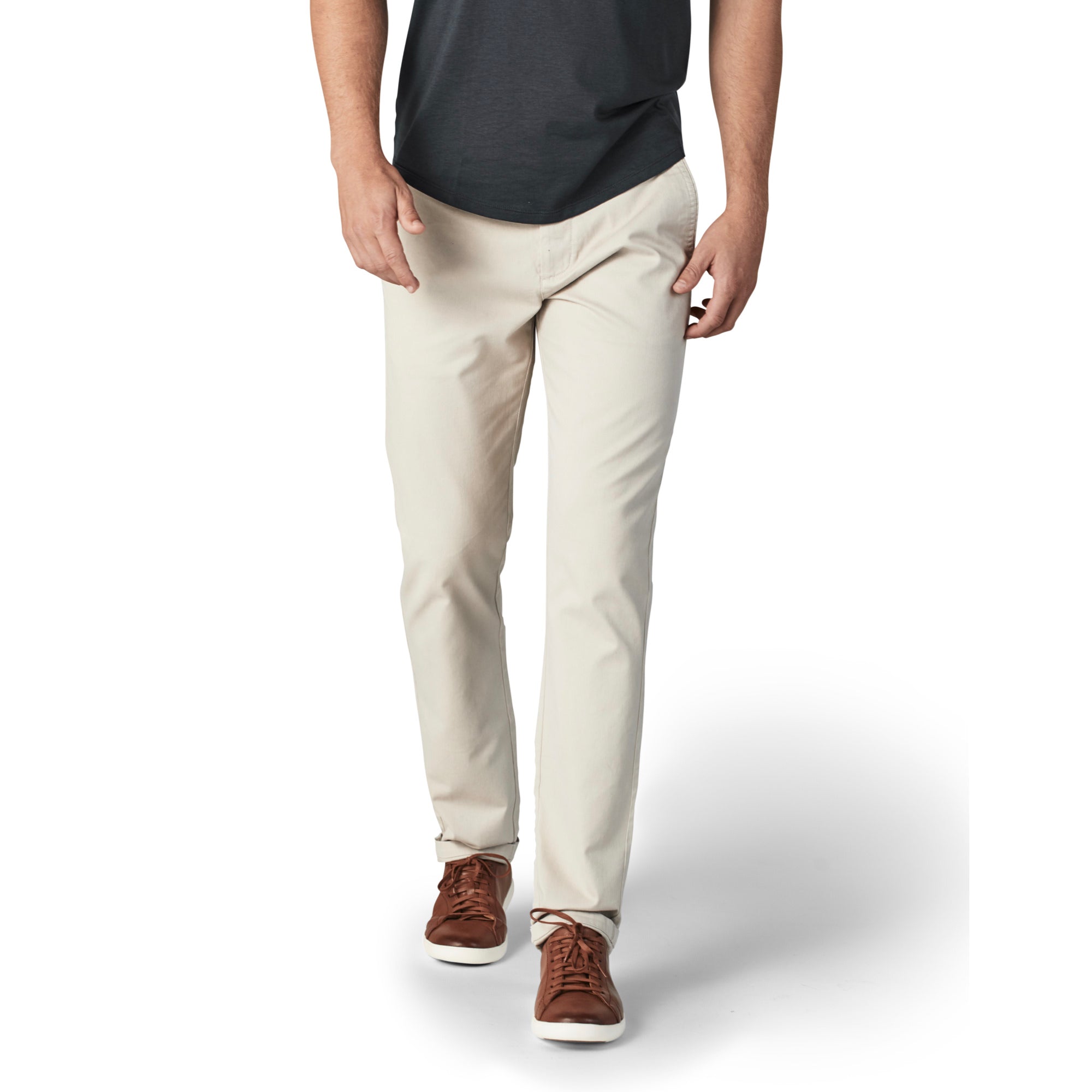 A pair of light khaki chinos designed for comfort and style, featuring a slim tapered fit and a curved waist for added comfort.