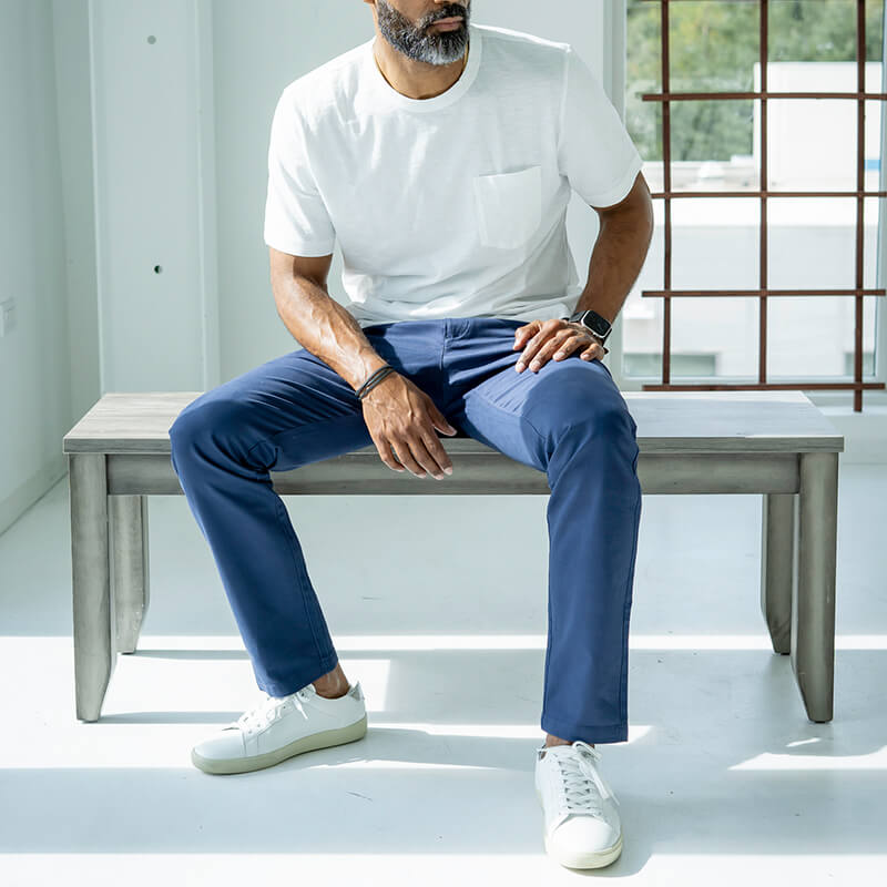 A pair of Feel Good Riverside Blue Chinos displayed on a neutral background, showcasing their slim tapered design and soft fabric.