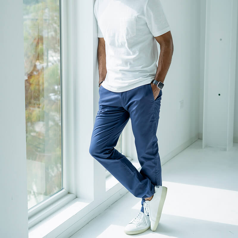 A pair of Feel Good Riverside Blue Chinos displayed on a neutral background, showcasing their slim tapered design and soft fabric.