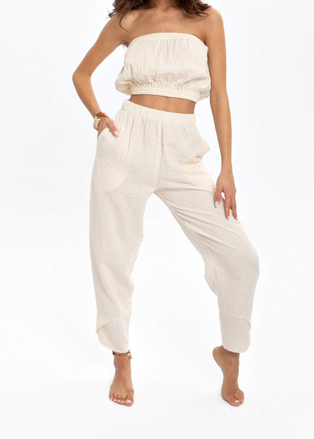 Hand woven white organic cotton pants with crinkle texture, featuring a high elastic waist for comfort and style.