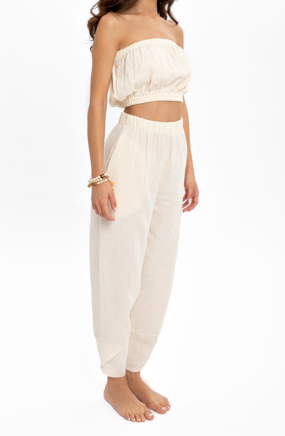 Hand woven white organic cotton pants with crinkle texture, featuring a high elastic waist for comfort and style.