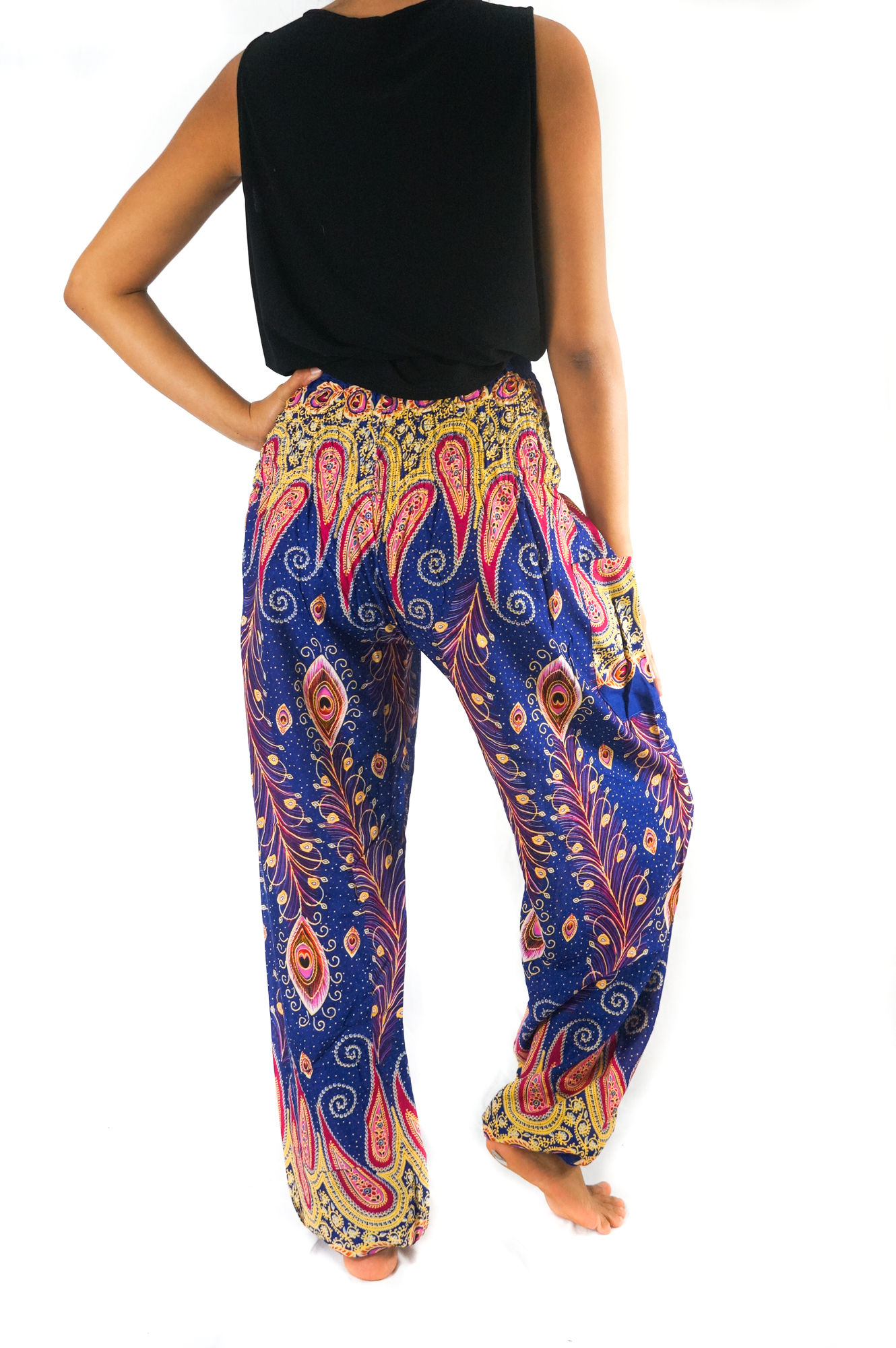 A pair of New Blue Peacock Boho Hippie Gypsy Pants featuring a vibrant peacock pattern, made from lightweight rayon fabric, showcasing their elastic waist and ankle design.