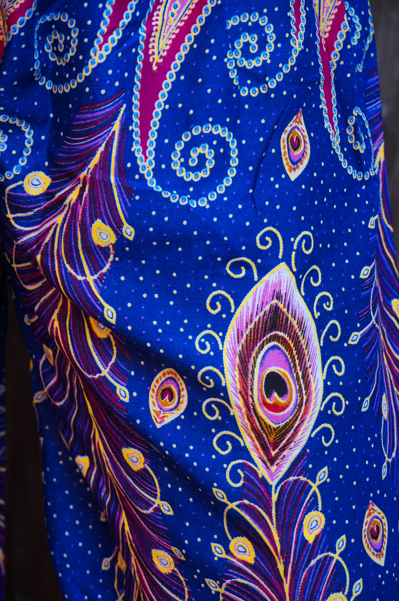 A pair of New Blue Peacock Boho Hippie Gypsy Pants featuring a vibrant peacock pattern, made from lightweight rayon fabric, showcasing their elastic waist and ankle design.