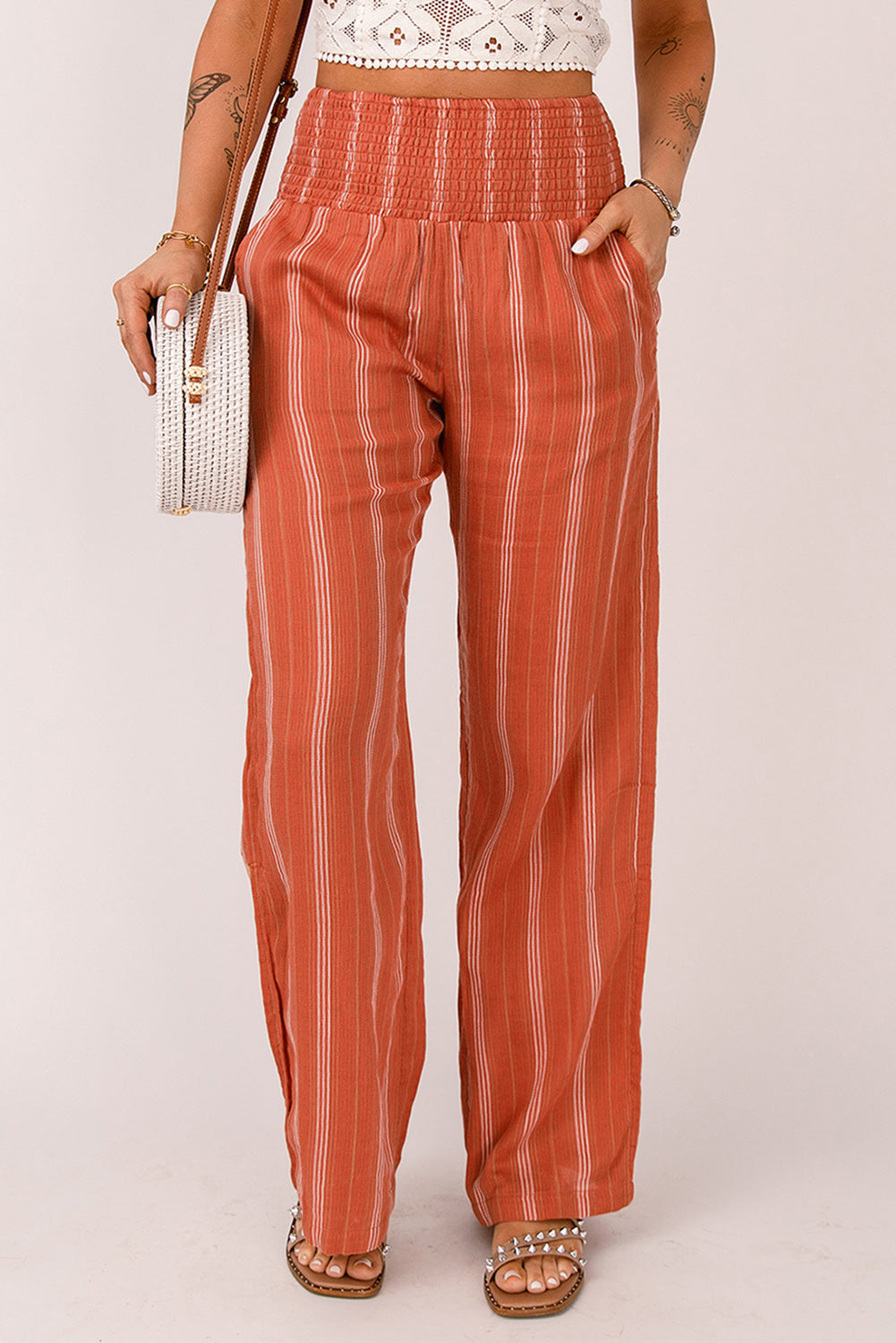 A pair of stylish orange high waist straight leg pants with a chic striped print, designed for a flattering fit and versatile wear.