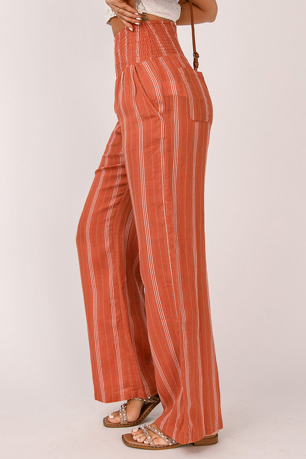 A pair of stylish orange high waist straight leg pants with a chic striped print, designed for a flattering fit and versatile wear.