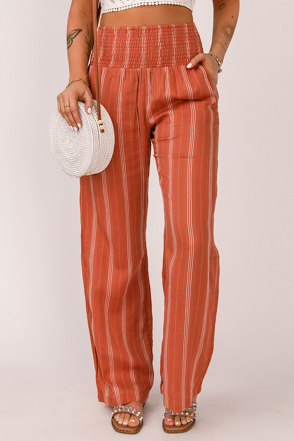 A pair of stylish orange high waist straight leg pants with a chic striped print, designed for a flattering fit and versatile wear.