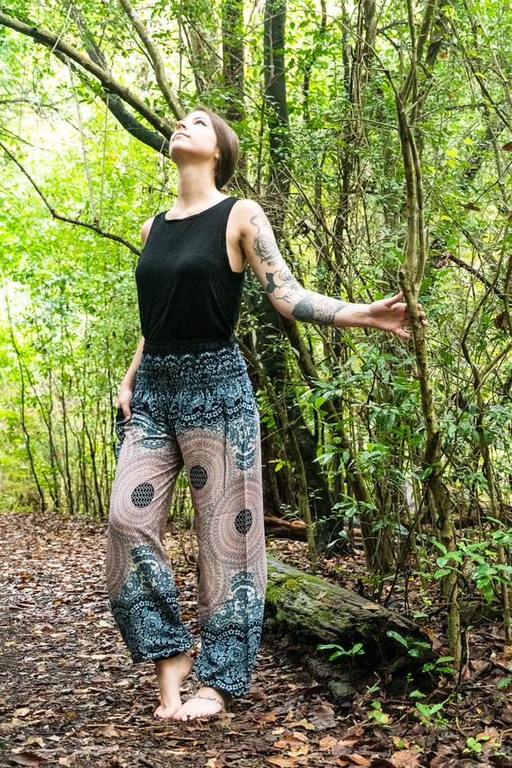 A pair of Pink MANDALA Women Boho Pants featuring a vibrant mandala pattern, elastic waist, and ankle cuffs, perfect for yoga and casual wear.